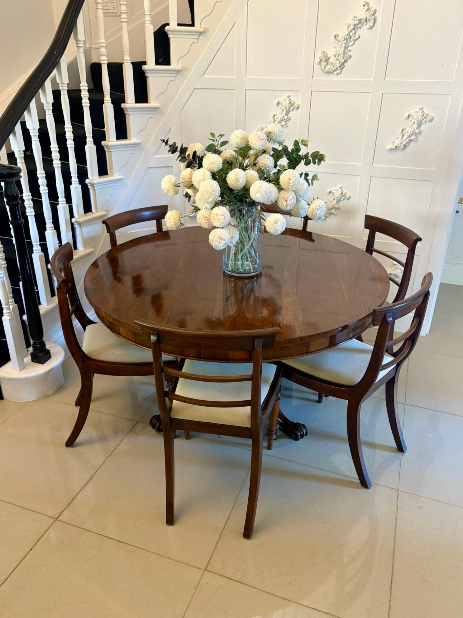 Outstanding quality antique Victorian carved rosewood circular dining table having an outstanding quality rosewood circular tilt top supported by a turned carved rosewood pedestal column standing on four shaped carved cabriole legs with carved