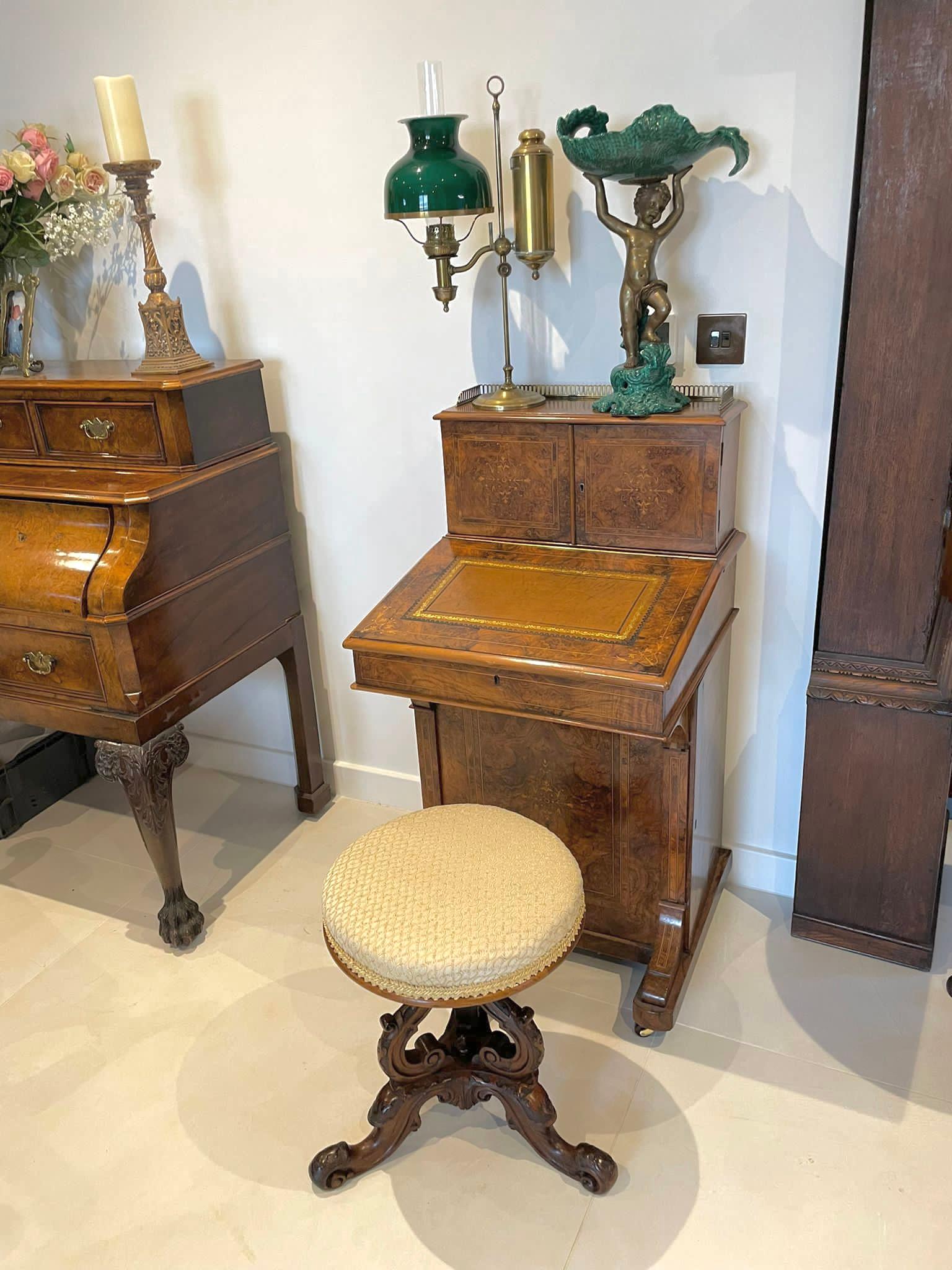 Outstanding quality antique Victorian carved walnut stool having a newly reupholstered circular shaped seat in a quality fabric above an outstanding quality carved solid walnut basket shaped base. It is raised on three lovely shaped carved solid