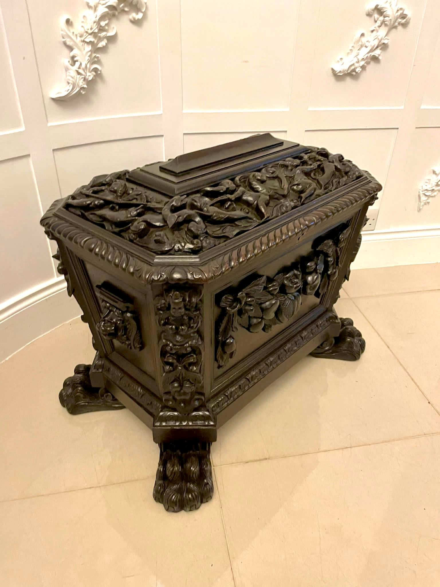 Outstanding quality antique Victorian freestanding carved oak wine cooler with outstanding quality relief carved decoration with putti and animals, reeded edge to the lift up top opening to reveal eight divisions, quality carved fruit decoration to