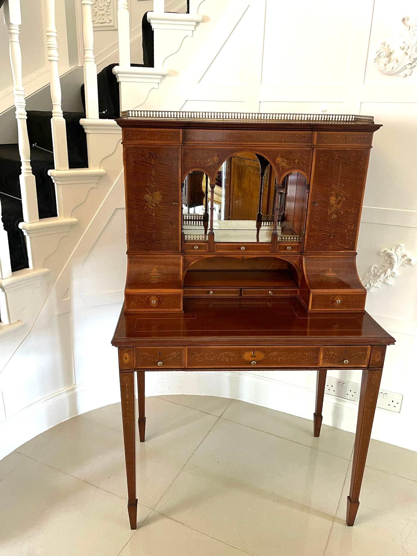 Outstanding quality antique Victorian inlaid mahogany freestanding desk the superstructure having the original brass gallery to the breakfront top above an arched mirror backed recess over three shallow drawers, original brass handles and further