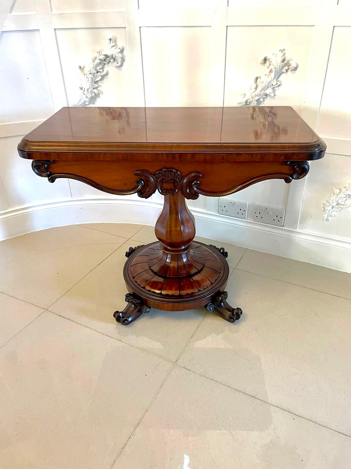 Outstanding quality antique Victorian mahogany card/side table having an outstanding quality mahogany fold over swivel top with a moulded edge opening to reveal a green baize interior above a shaped carved mahogany frieze.  It is supported on an