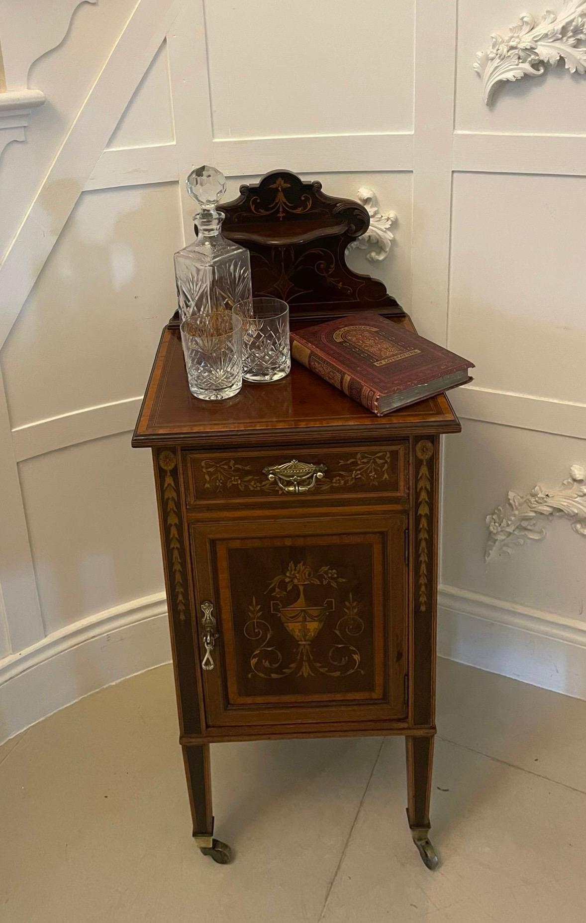 Outstanding quality antique Victorian mahogany marquetry inlaid bedside cabinet having an attractive and quality shaped marquetry inlaid back above a mahogany top with satinwood crossbanding above a single drawer inlaid with flowers, leaves, ribbons