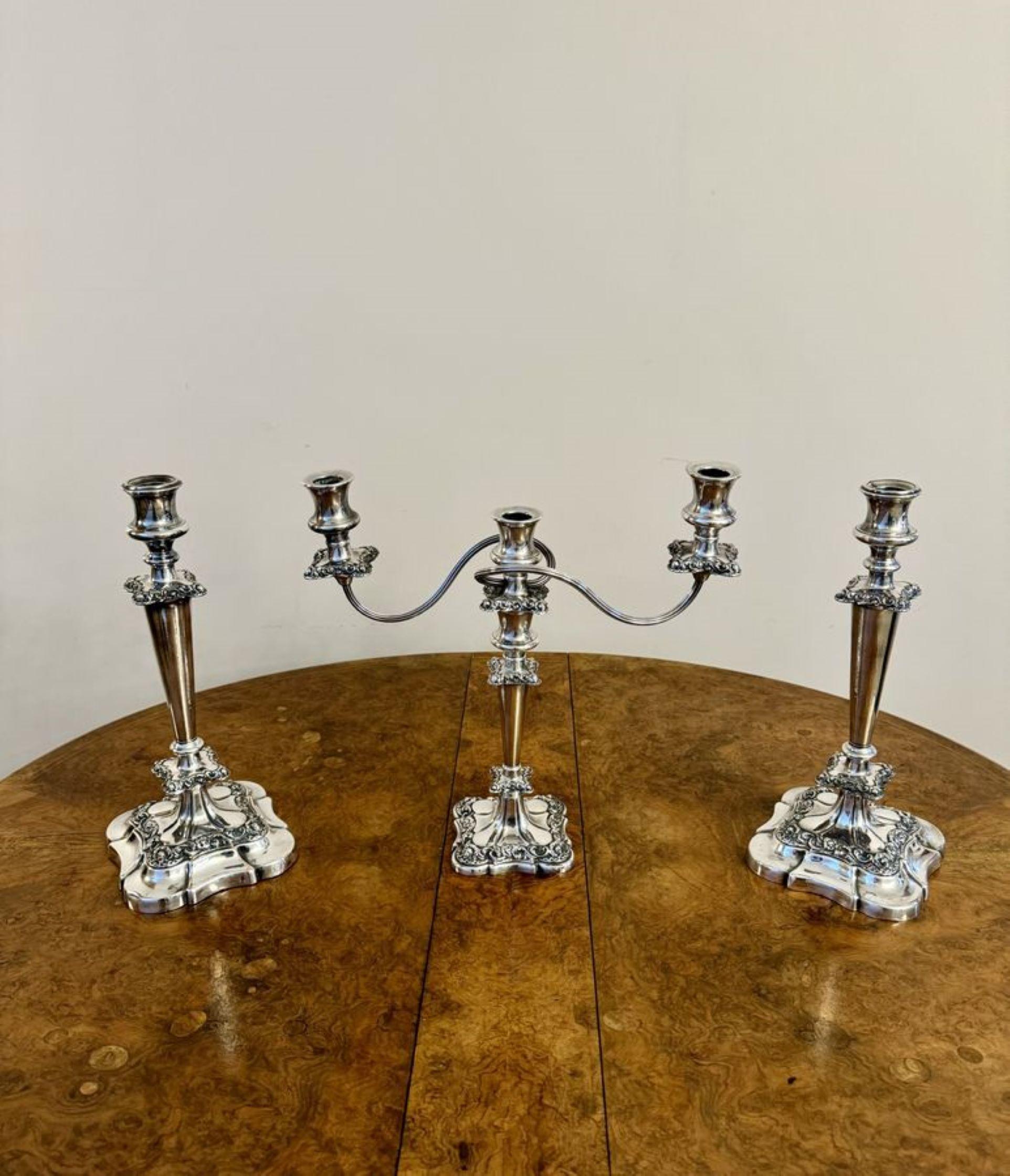 Outstanding quality antique Victorian ornate silver plated candelabra and candlestick set having a fine quality antique Victorian silver plated candelabra accompanied by the matching pair of candlesticks, the candelabra having three light branches,