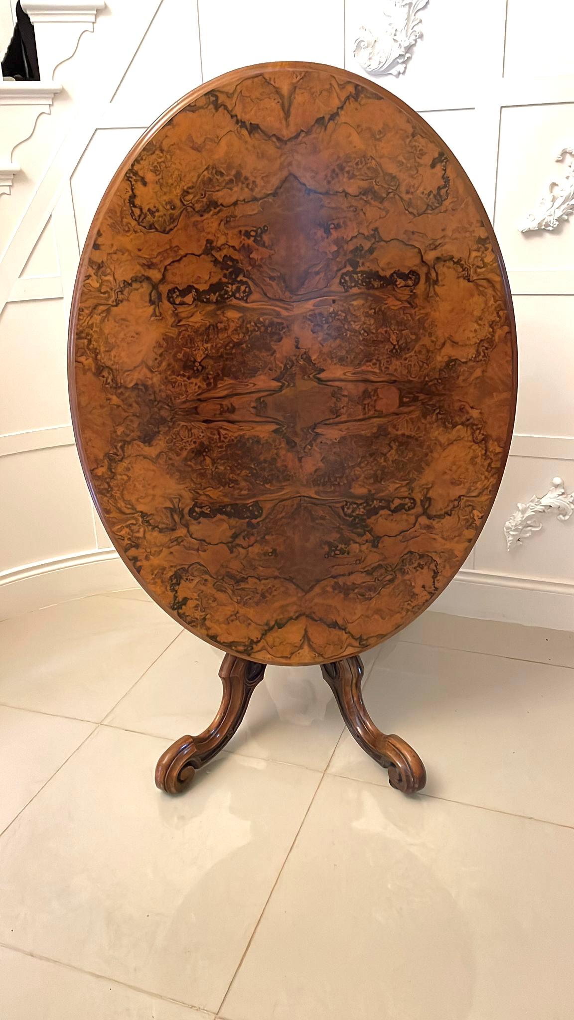Outstanding quality antique Victorian oval burr walnut centre table having an outstanding quality oval burr walnut tilt top with a thumb moulded edge supported by a superb quality carved solid walnut turned shaped column raised by four carved solid