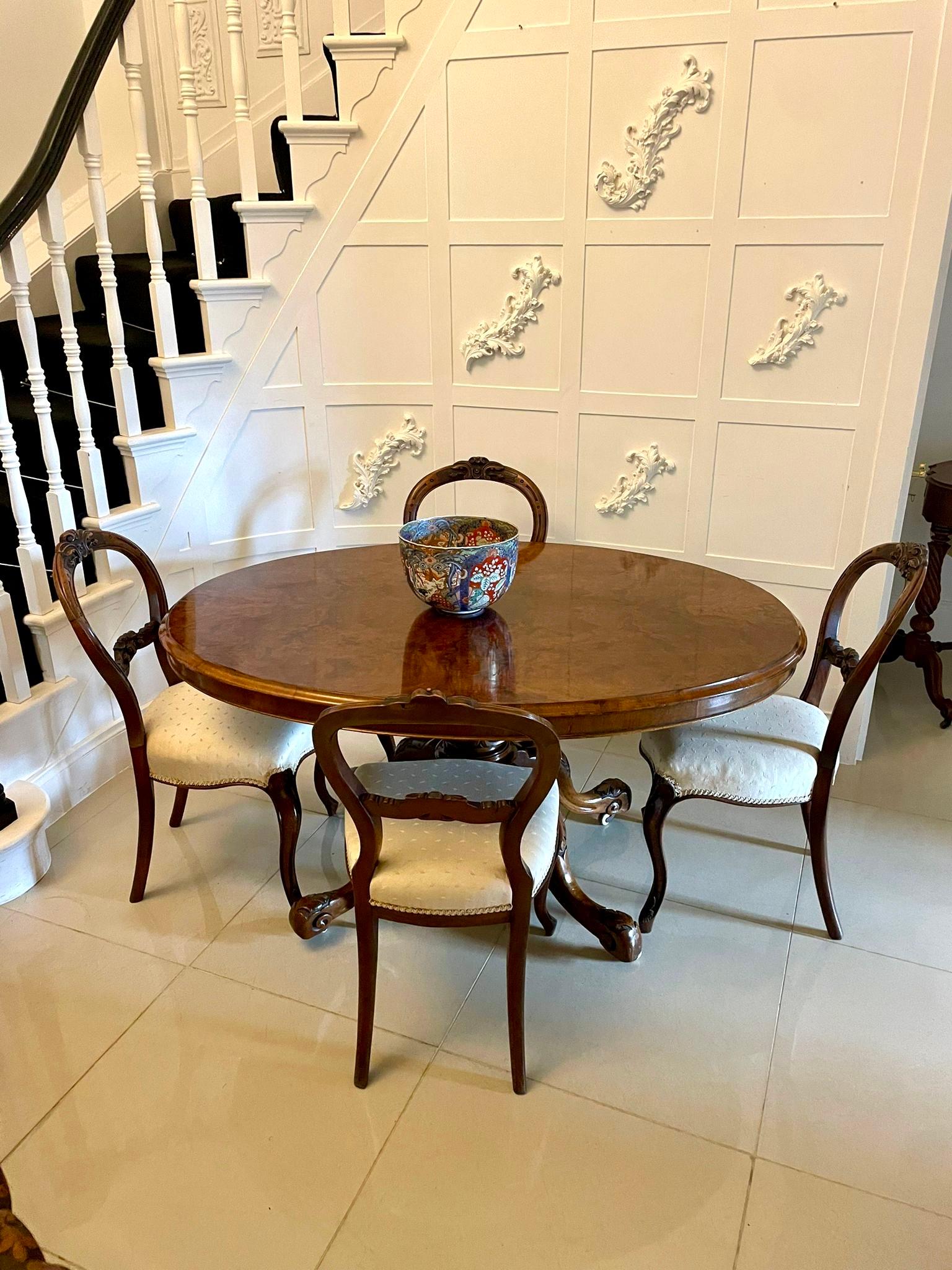 Outstanding quality antique Victorian oval burr walnut dining table having an outstanding oval burr walnut top with a thumb moulded edge supported by a turned carved solid walnut pedestal column standing on four shaped carved cabriole legs with