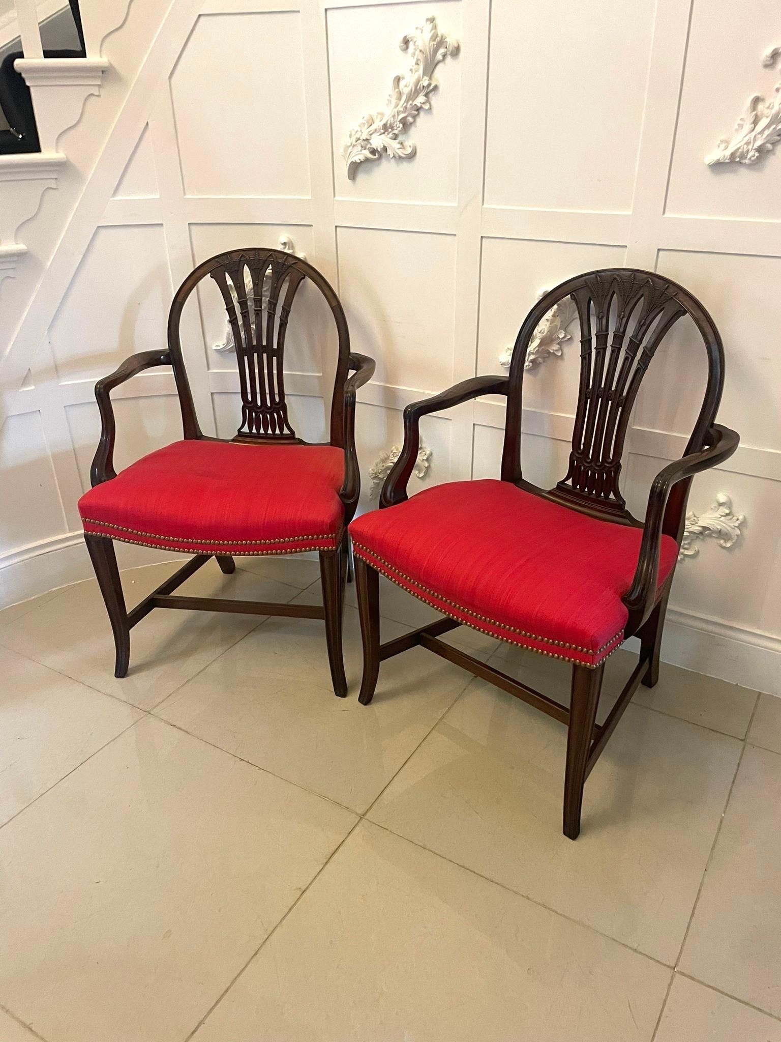 Outstanding quality antique Victorian pair of carved mahogany desk chairs having a marvellous quality carved mahogany shaped back, newly reupholstered seats in a quality fabric, superb quality carved mahogany shaped open arms standing on square