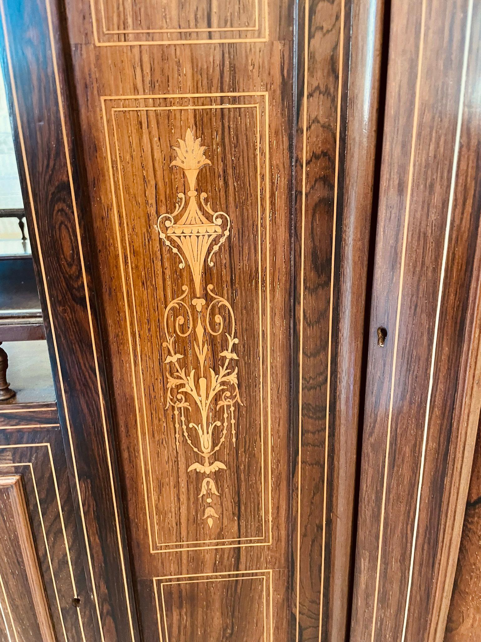 Outstanding quality antique Victorian rosewood inlaid side cabinet having a fantastic quality rosewood inlaid back with five bevelled edge mirrors, attractive shaped shelves and pediment above a glorious shaped rosewood inlaid sideboard with three