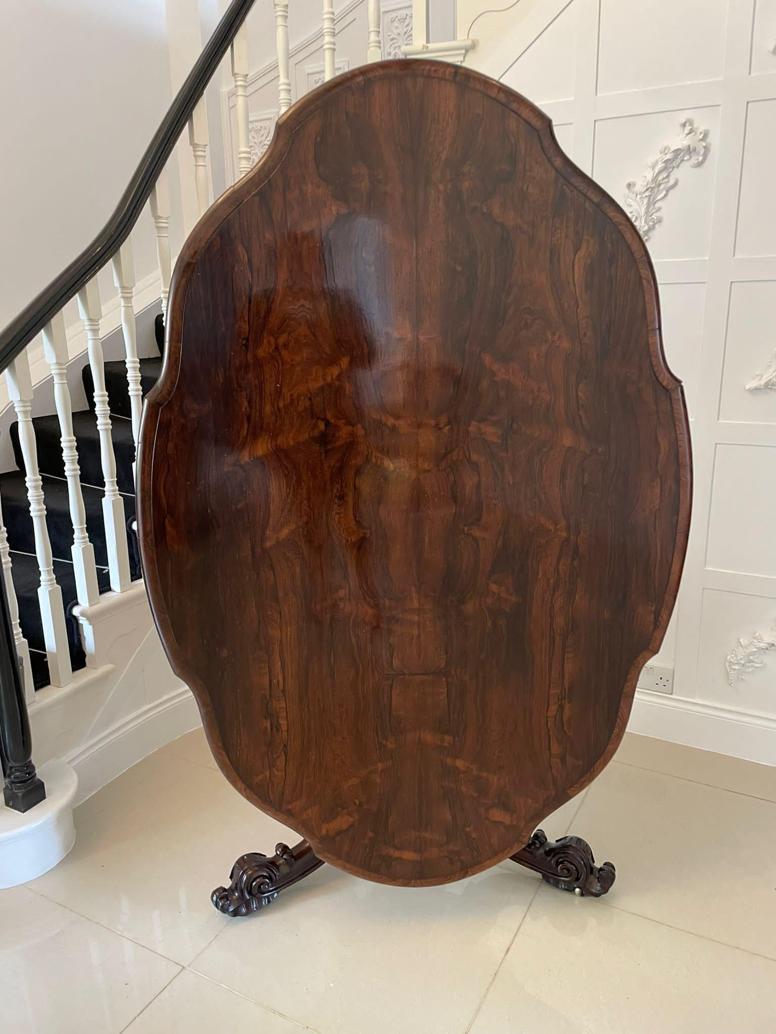 Outstanding quality antique Victorian rosewood shaped top centre table having an outstanding quality rosewood shaped tilting top with a thumb moulded edge supported on a circular turned pedestal column with a beautiful carved collar standing on