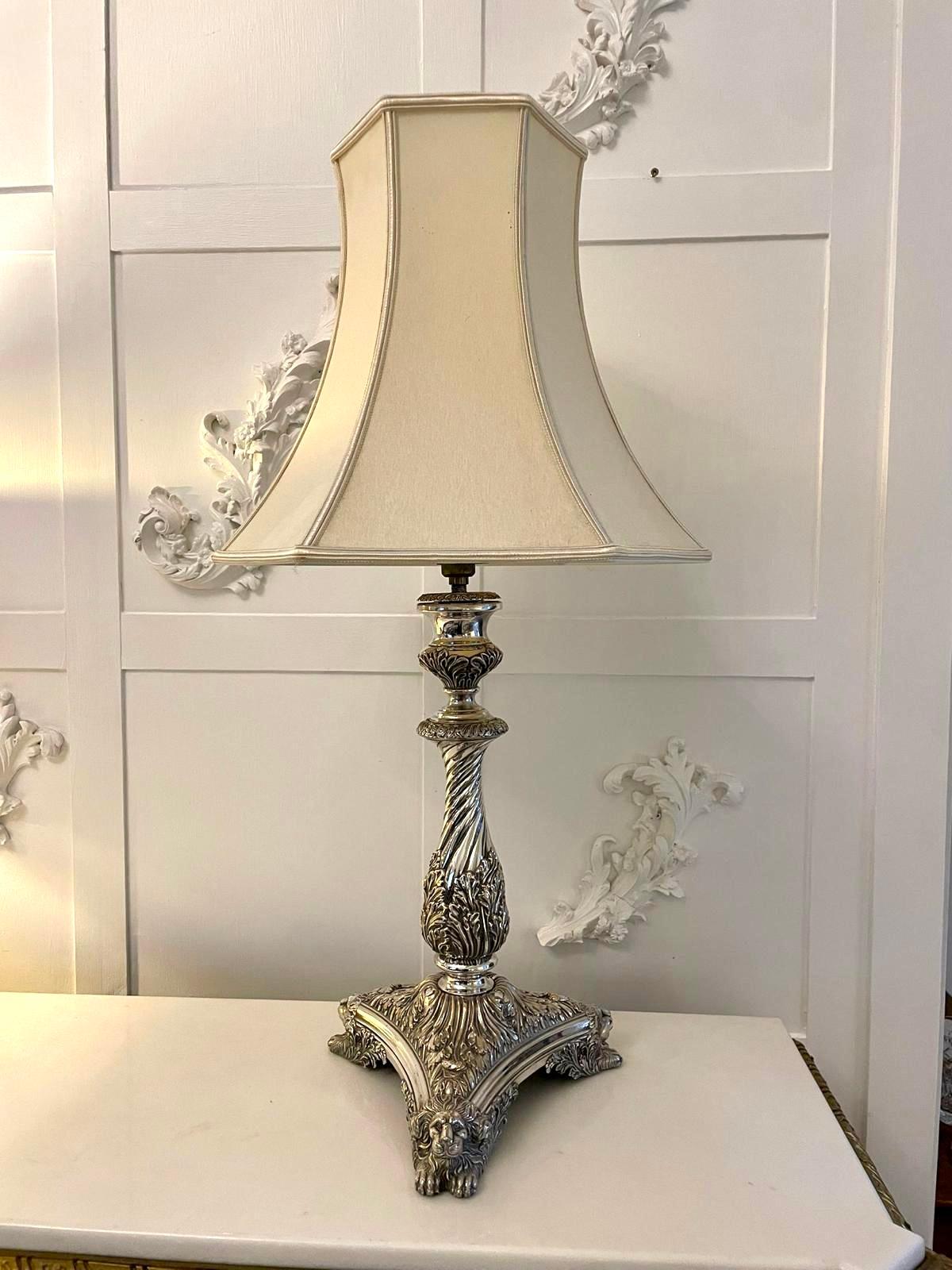 Outstanding quality antique Victorian ornate silver plated table lamp having a pretty shaped ornate column standing on an attractive shaped platform base with lions heads and paw feet. Shades not included.

A splendid example boasting a fabulous