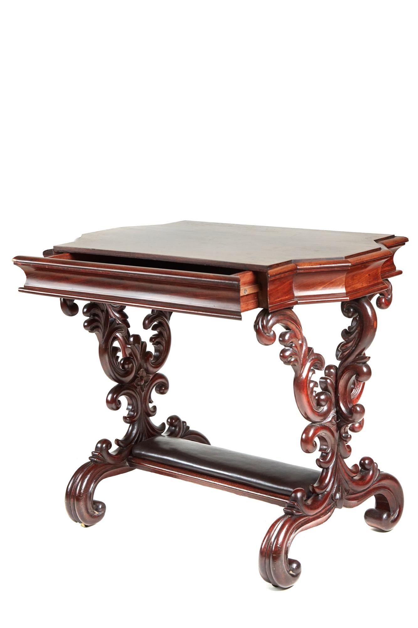 This is an outstanding quality 19th century antique carved mahogany freestanding centre table with a very attractive shaped top with fitted drawer to the shaped frieze. It has fantastic elaborately carved scroll supports and stands on elegant carved
