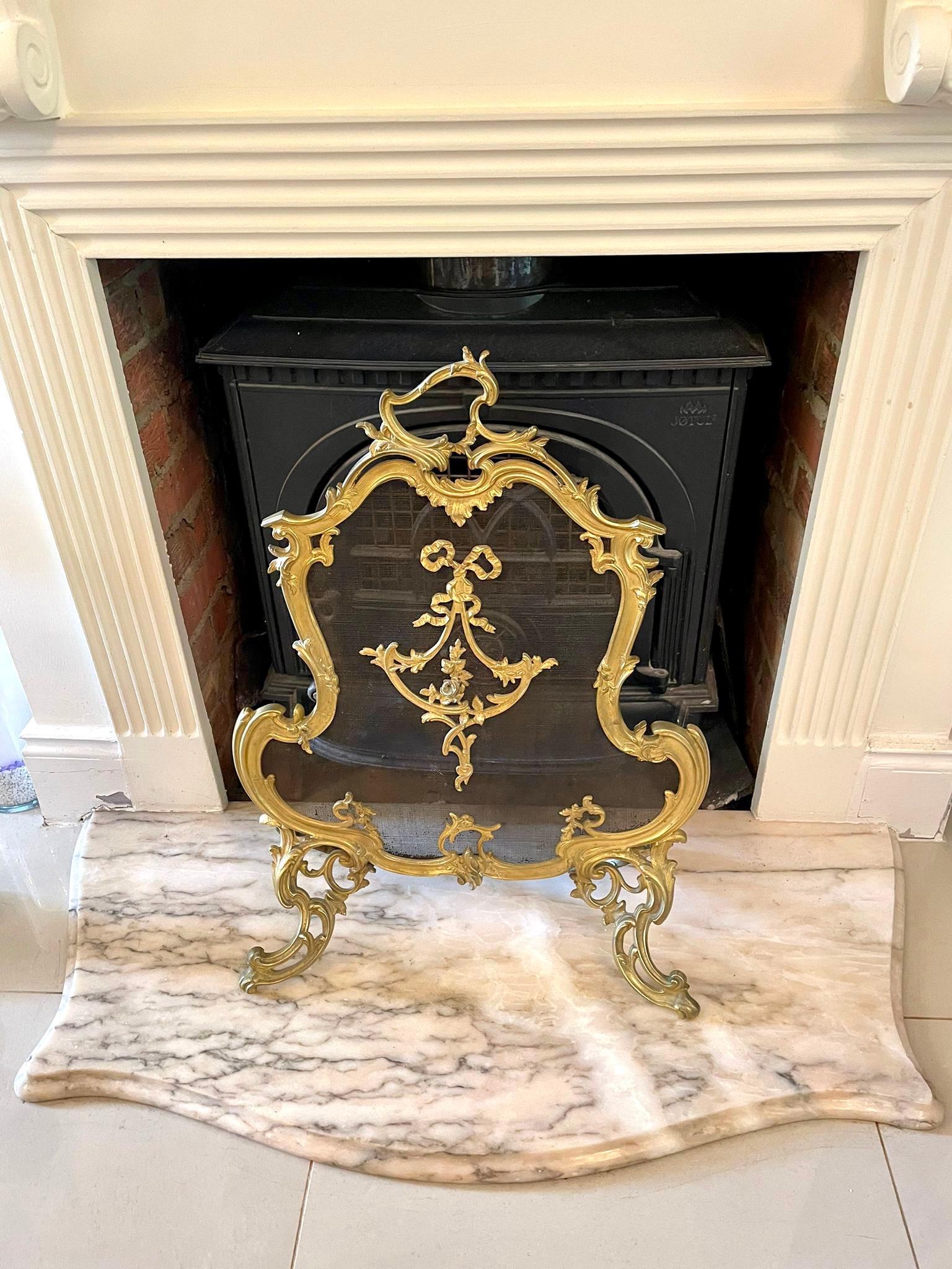 Outstanding quality French 19th century ornate gilt ormolu fire screen having a highly ornate mesh fire screen with ‘C’ scroll, swag ribbon and floral detail, beautifully shaped ornate handle to the top and ornate 
shaped gilt ormolu legs.

A