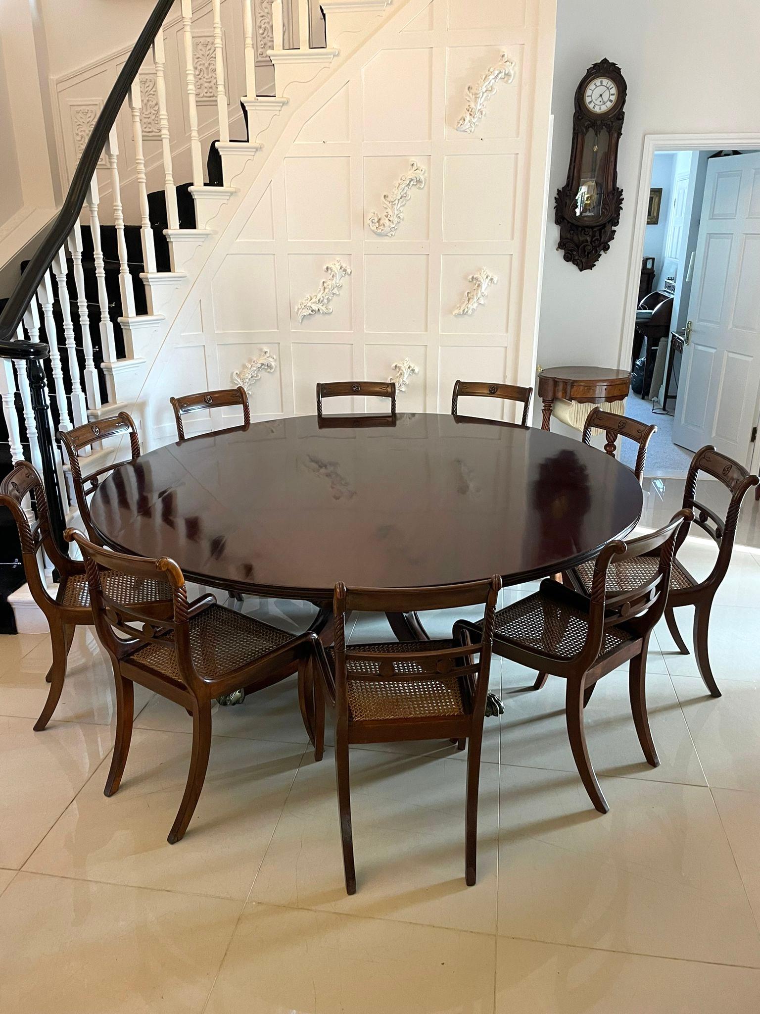 Outstanding quality large 10 seater antique regency quality mahogany round dining table having a large quality figured mahogany round tilt top with a moulded edge supported by a very grand turned pedestal column standing on 4 four shaped reeded