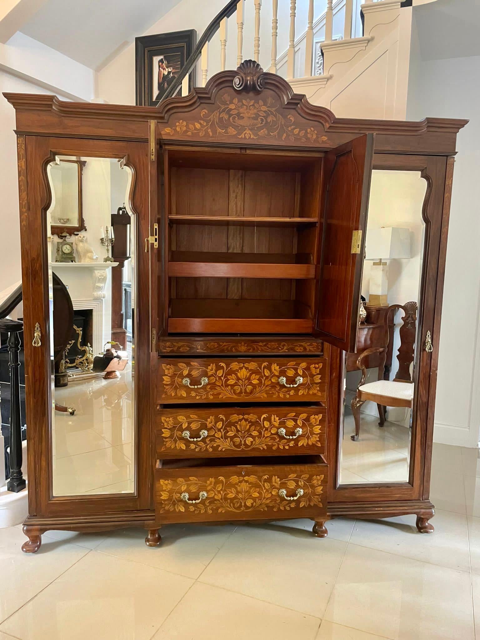 Outstanding quality large antique Victorian figured walnut floral marquetry inlaid wardrobe 
having an outstanding quality figured walnut floral marquetry inlaid carved cornice above a pair of moulded panelled floral marquetry inlaid doors opening