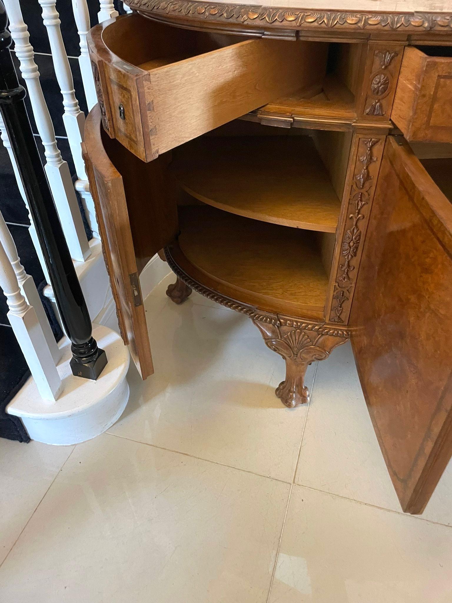 Outstanding quality large antique carved burr walnut bow fronted sideboard having an outstanding quality burr walnut bow fronted top with a carved edge above a bow fronted centre drawer with original carved walnut knobs flanked by unusual swing out