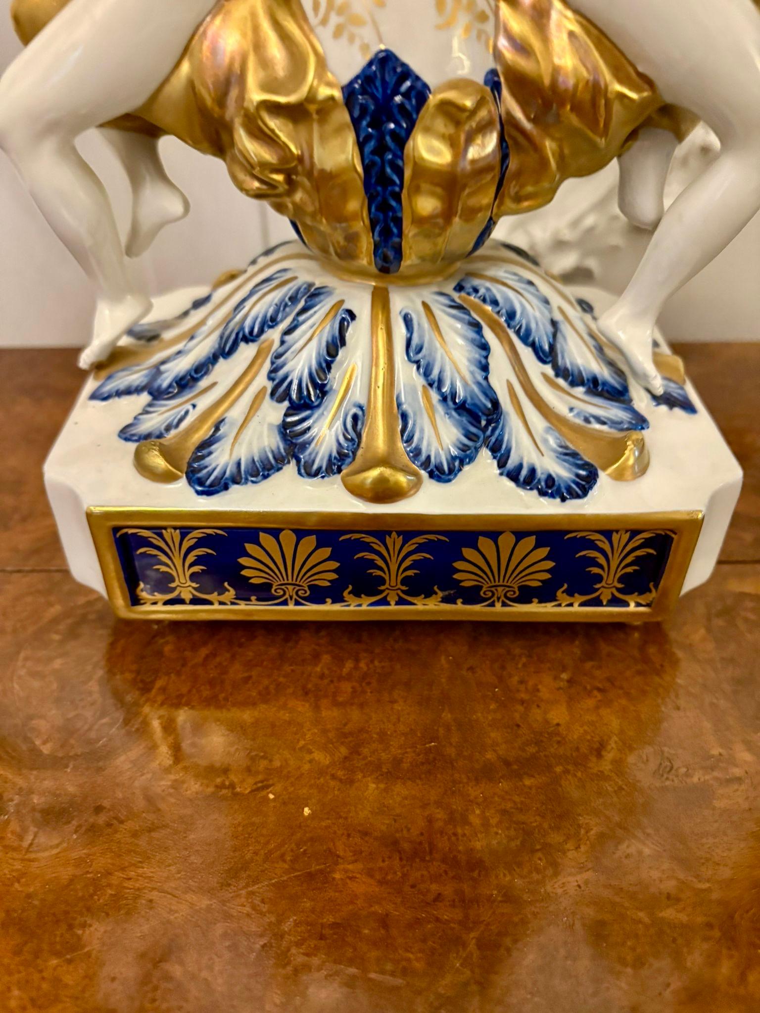 Outstanding quality large antique Victorian French porcelain and gilded metal clock set consisting of a pair of candelabra and a mantle clock. The candelabras having ornate gilded brass and porcelain five branch tops above a porcelain column