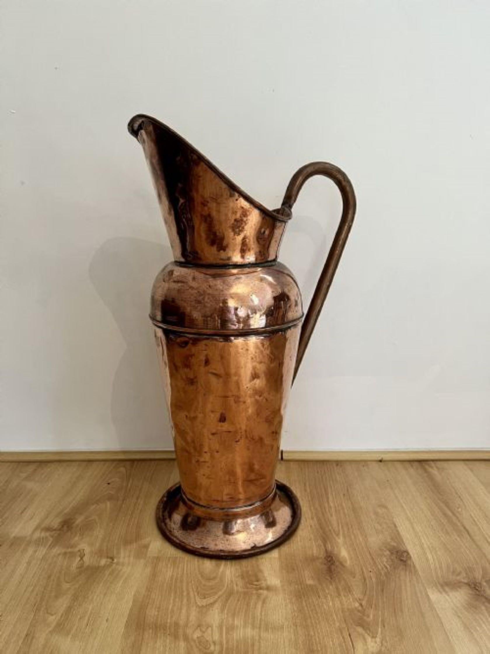 Outstanding quality large antique Victorian copper jug having a shaped handle to the back with a shaped tapering body standing on a circular base.