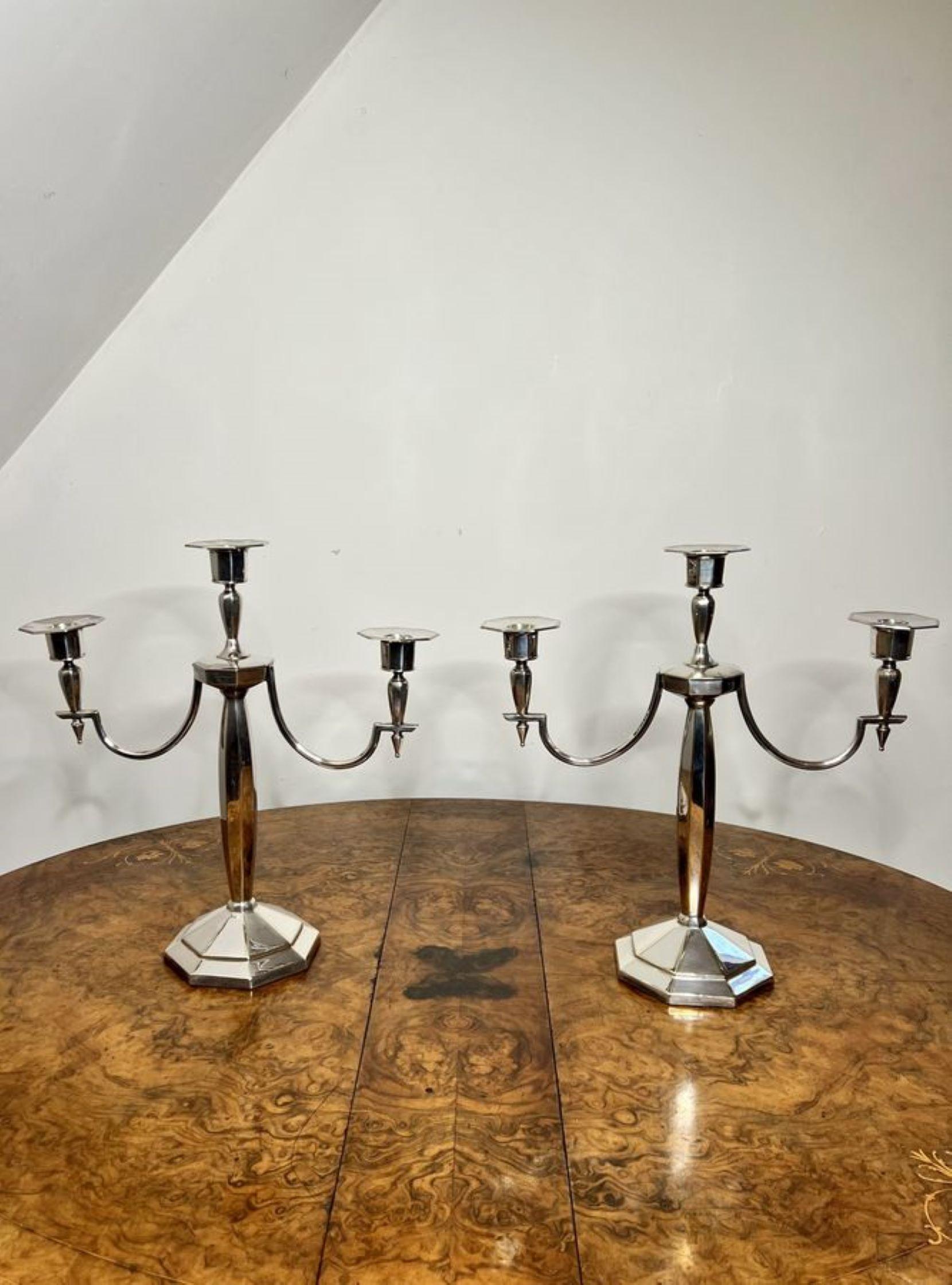 Outstanding quality pair of antique Edwardian silver plated candelabras, having a quality pair of antique Edwardian silver plated candelabras, with three light branches above a shaped column standing on a shaped base.

D. 1900