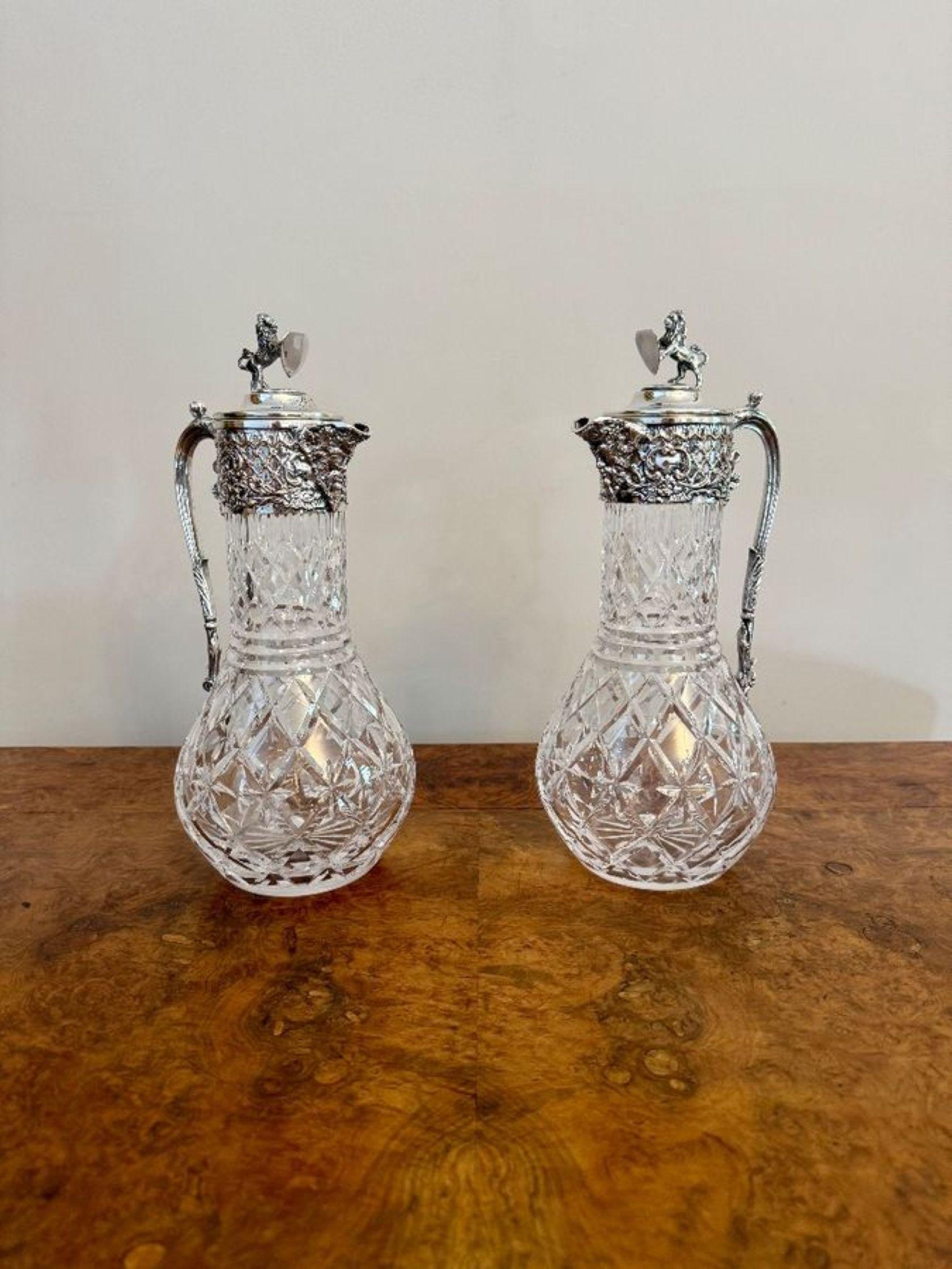 Outstanding quality pair of antique Edwardian silver plated claret jugs, having a quality pair of antique Edwardian claret jugs with ornate silver plated tops, figural spouts to the front and a shaped ornate handle to the back with grapes and vines,