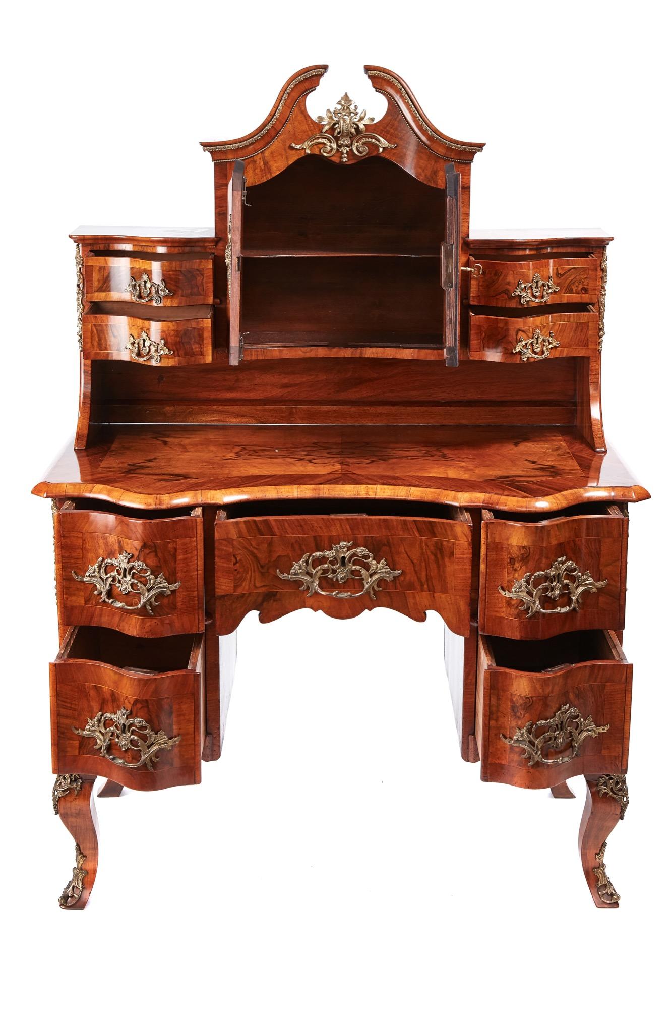 Outstanding quality Victorian French burr walnut desk, top section having a swan-neck pediment, two serpentine shaped doors and four serpentine shaped drawers in fantastic quality burr walnut with original rococco gilt brass handles and mounts, the