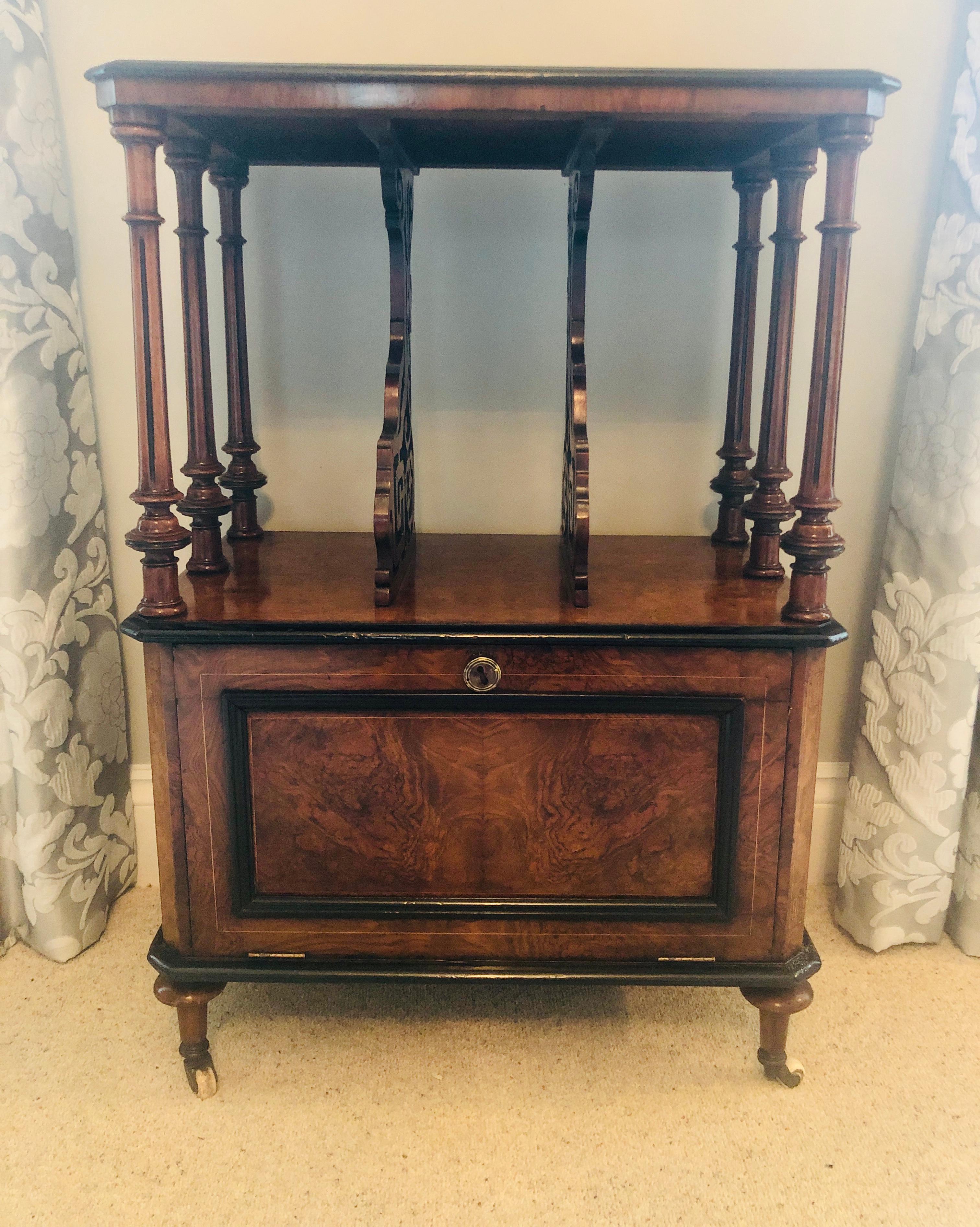 Outstanding quality Victorian inlaid burr walnut music cabinet/canterbury. This exceptional piece boasts an original brass pierced gallery above a fine inlaid burr walnut top with a satinwood inlay decoration which is raised on 6 delightfully carved