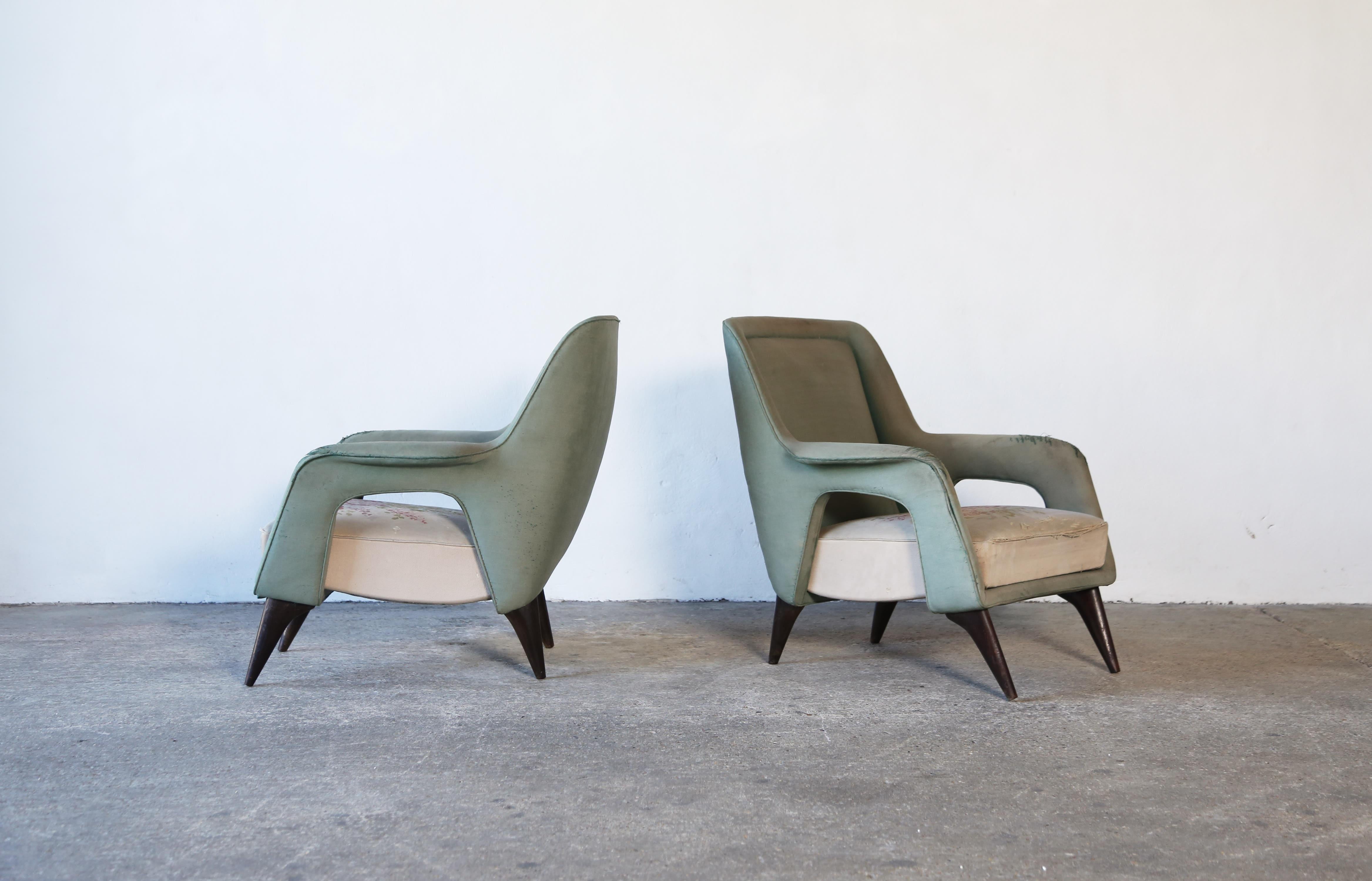 An extraordinary, rare pair of Italian 1950s armchairs.  Structurally sound, but the original upholstery is worn out so the chairs are sold for the customer to recover in their own choice of fabric.  Fast shipping worldwide.

