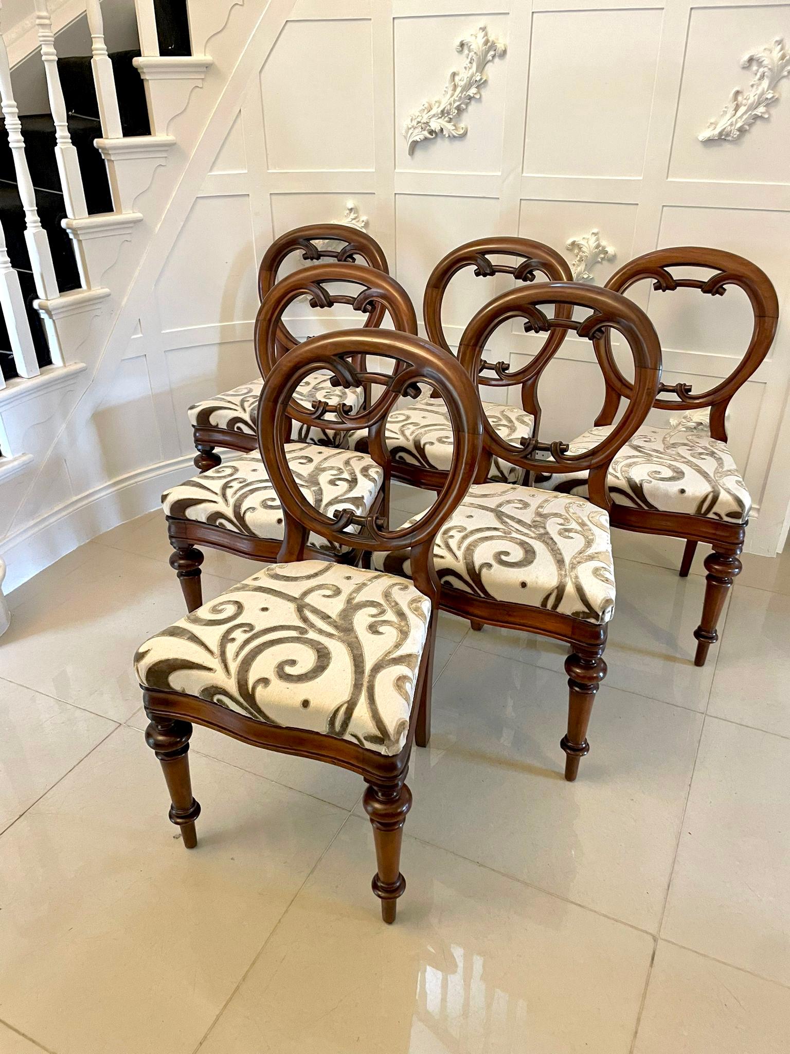 Outstanding set of six 19th Century Victorian antique mahogany balloon back dining chairs having circular backs and a beautifully carved lower rail standing on elegant turned fluted legs to the front and out swept back legs. The drop in seats have