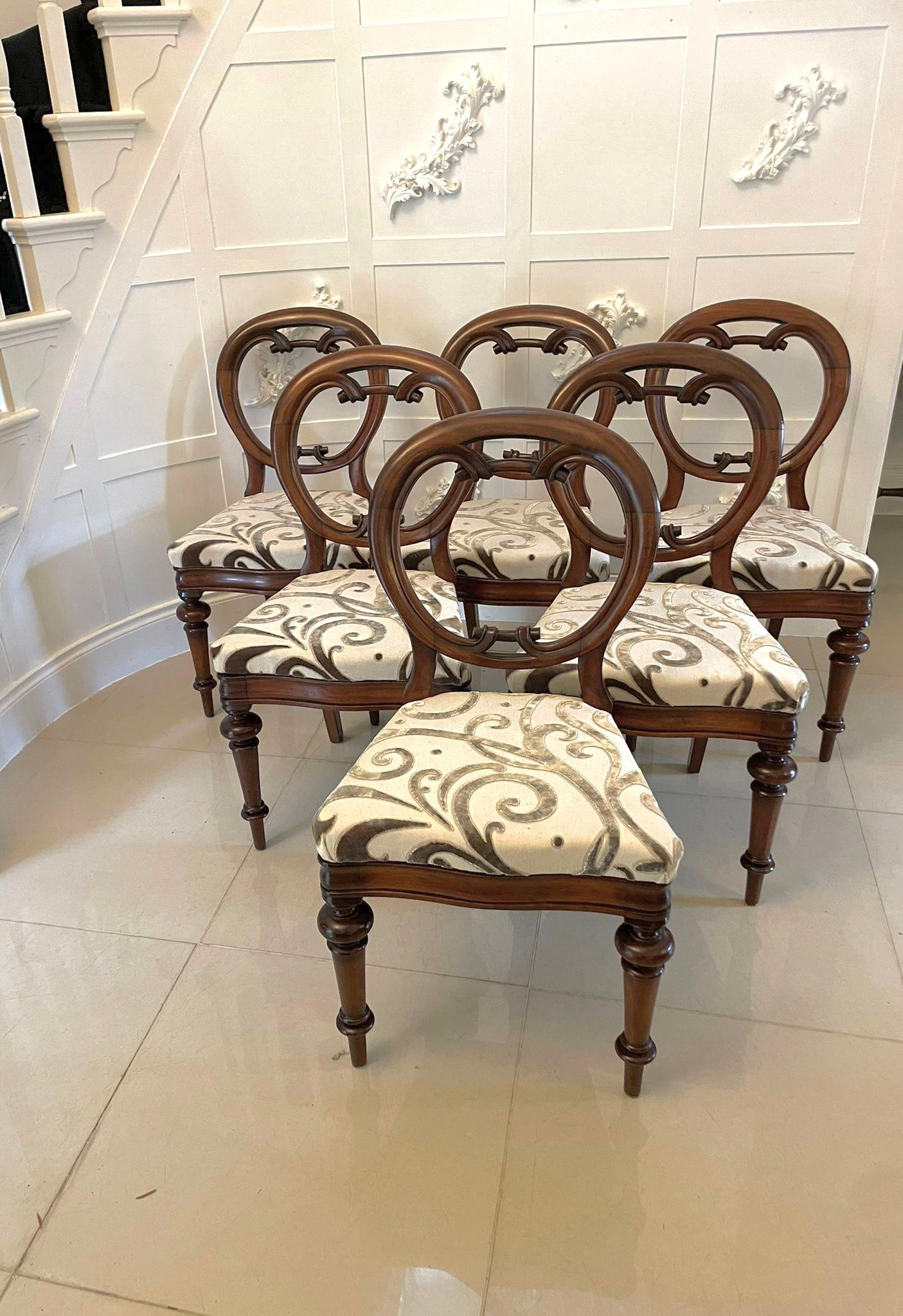Outstanding set of six 19th Century Victorian antique mahogany balloon back dining chairs having circular backs and  a beautifully carved lower rail standing on elegant turned fluted legs to the front and out swept back legs. The drop in seats have
