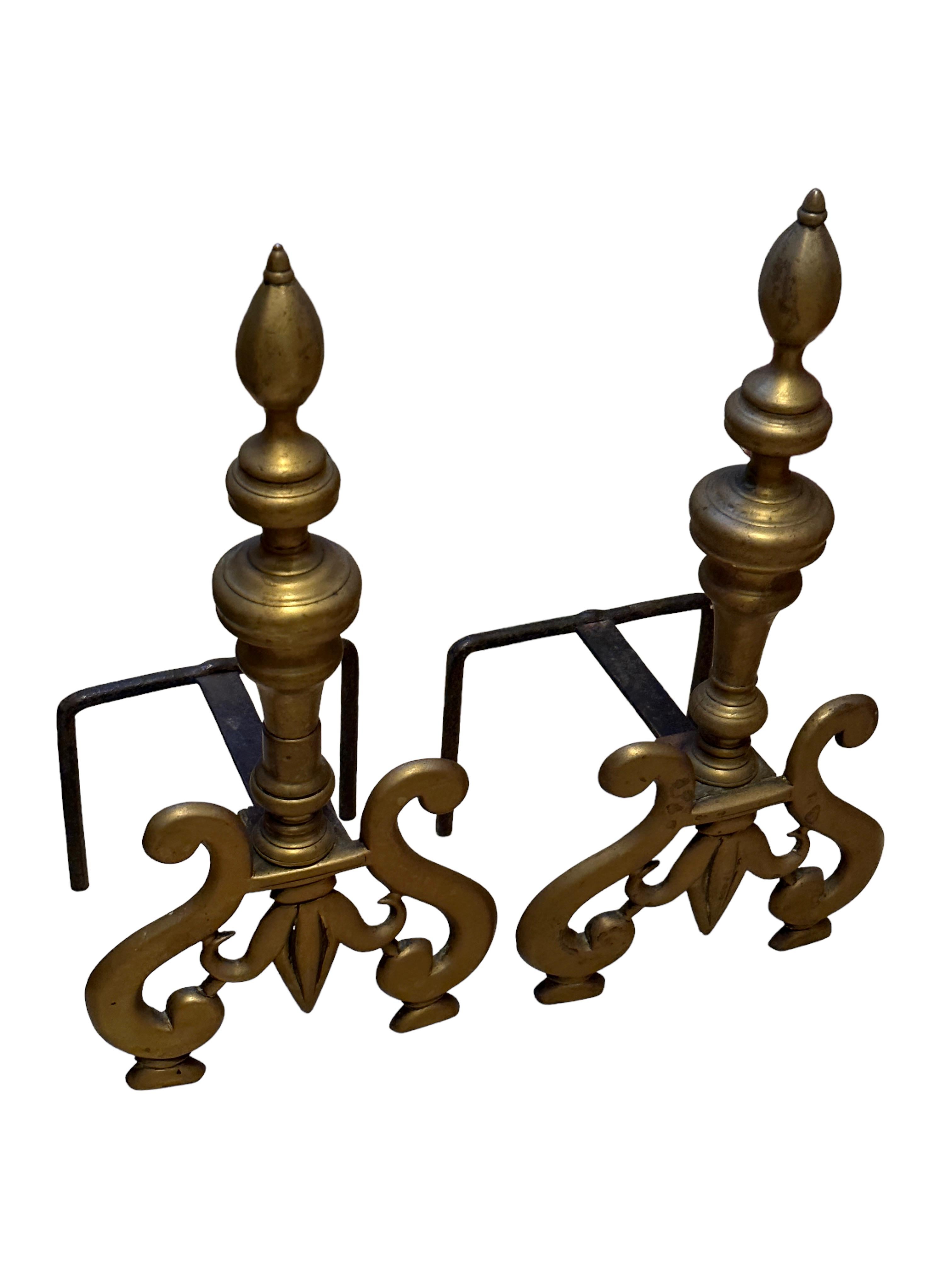 Beautiful stunning sculptural andirons. Showing french lilies on the front. A beautiful nice pair for your fire place. They are in original used condition.