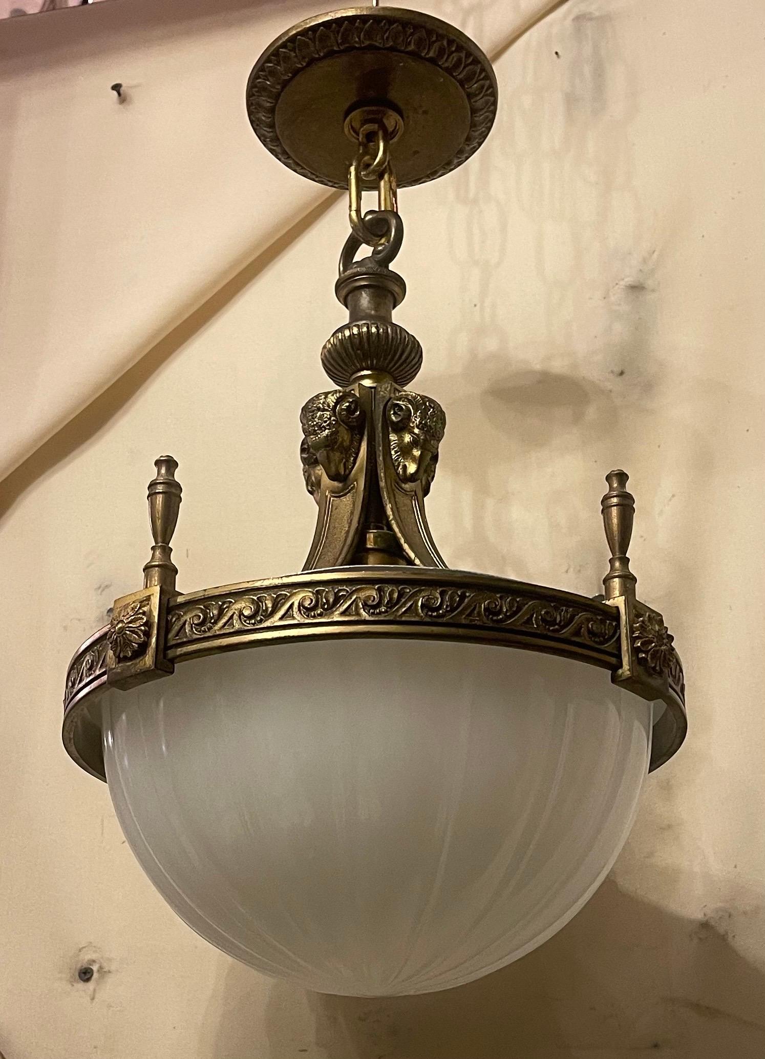 An Outstanding Set Of 3 Gilt Bronze & Opaline Ribbed Glass Caldwell Manner Chandelier Fixtures In The Neoclassical Motif. They Are Adorned With Rams Head Masks And Urns Surrounding The Top Rim. The Detail And Crispness Of The Bronze Work Is