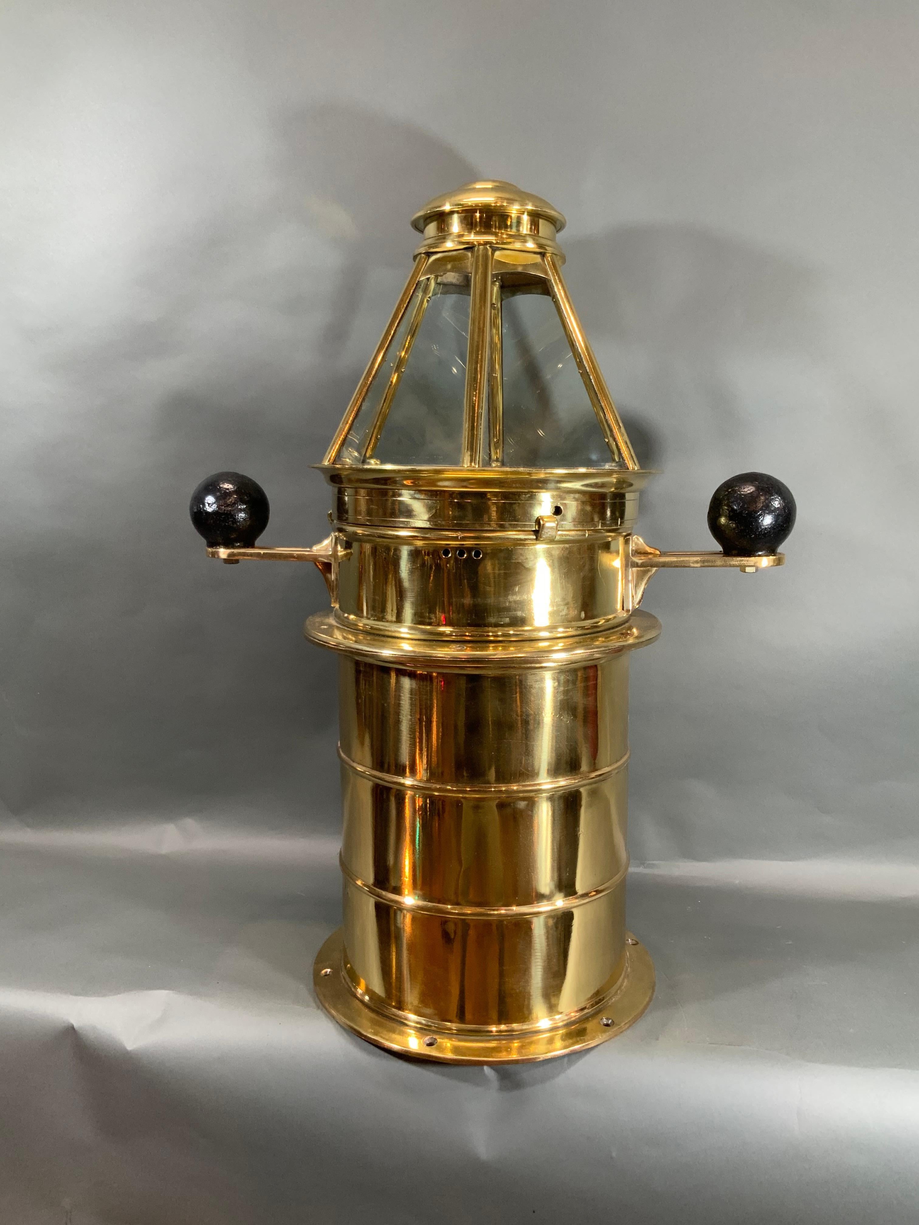 Solid brass yacht binnacle with highly polished and lacquered finish. Fitted with a compass by Ritchie of Boston. The binnacle is topped with a six sided skylight top. The base is solid brass. This is an outstanding relic. Iron compensating balls