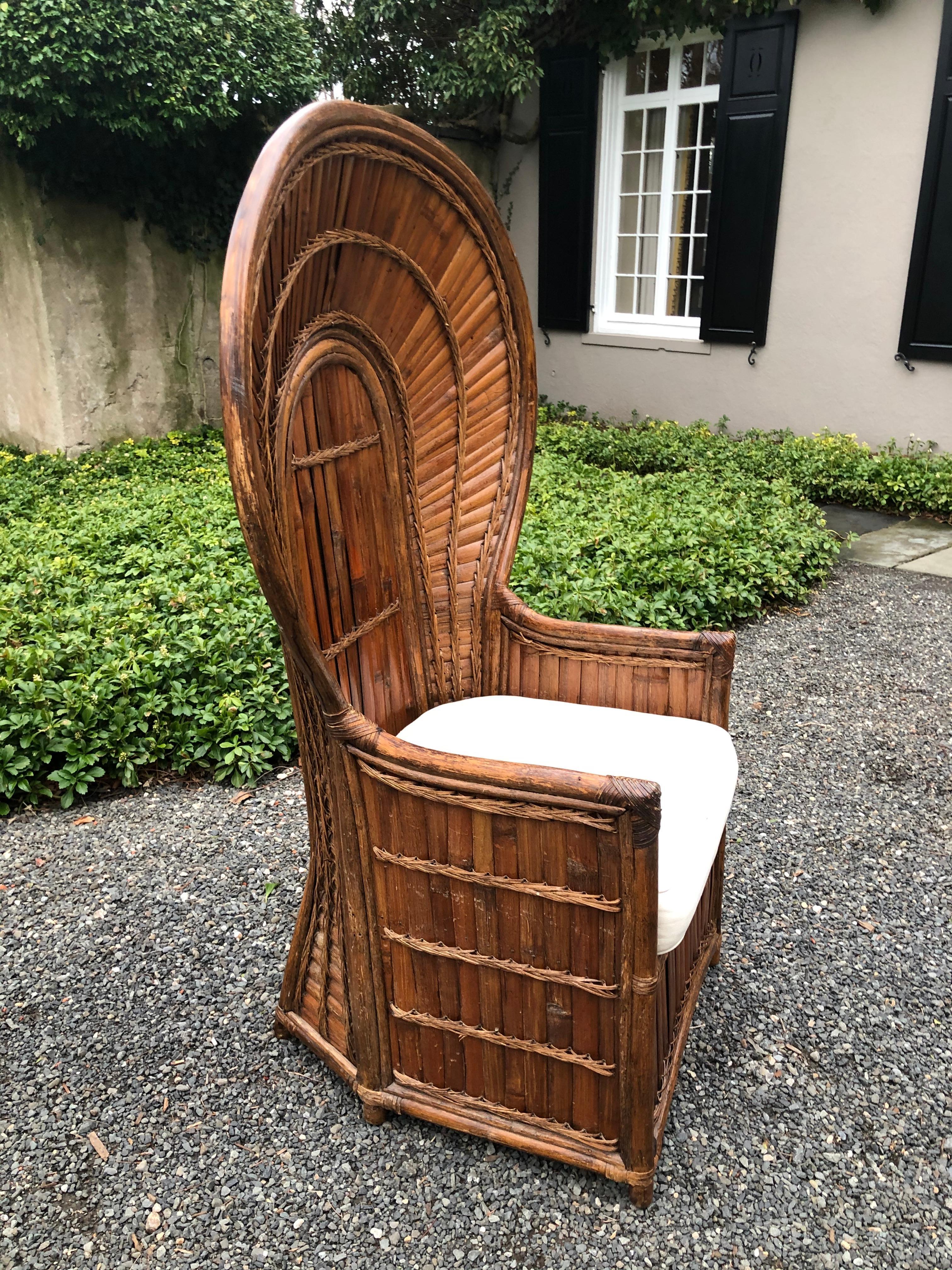 Outstanding split bamboo Peacock chair with removable seat that exposes a hidden storage compartment. It is rare to find this chair in such perfect condition; there are no breaks in the bamboo or rattan. The bamboo has a wonderful mellow color.