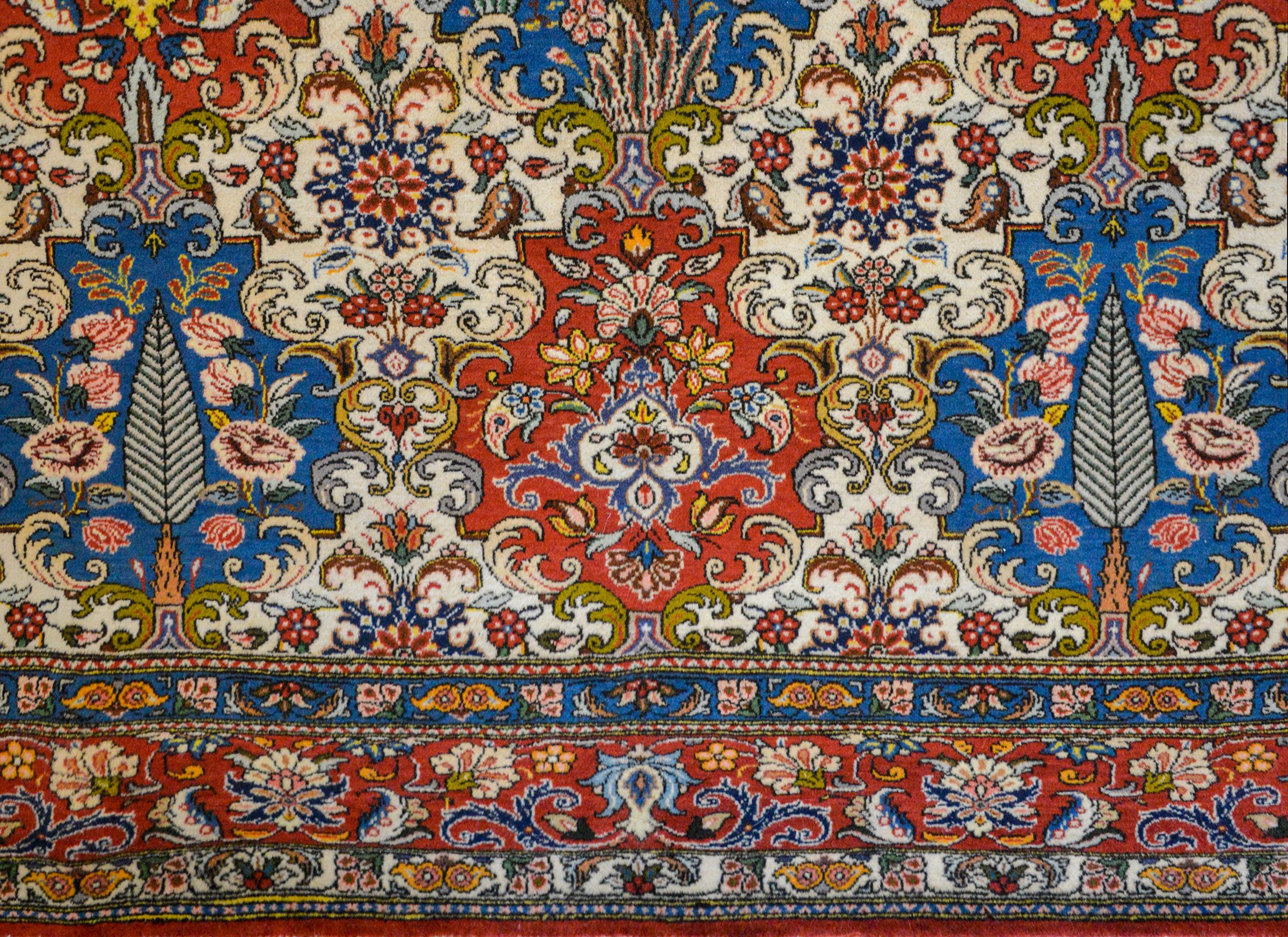 An outstanding vintage Persian Bakhtiari rug with a wonderful Baroque pattern containing myriad trees and floral medallions amidst more scrolling flowers and leaves, and surrounded by multiple floral partnered borders.