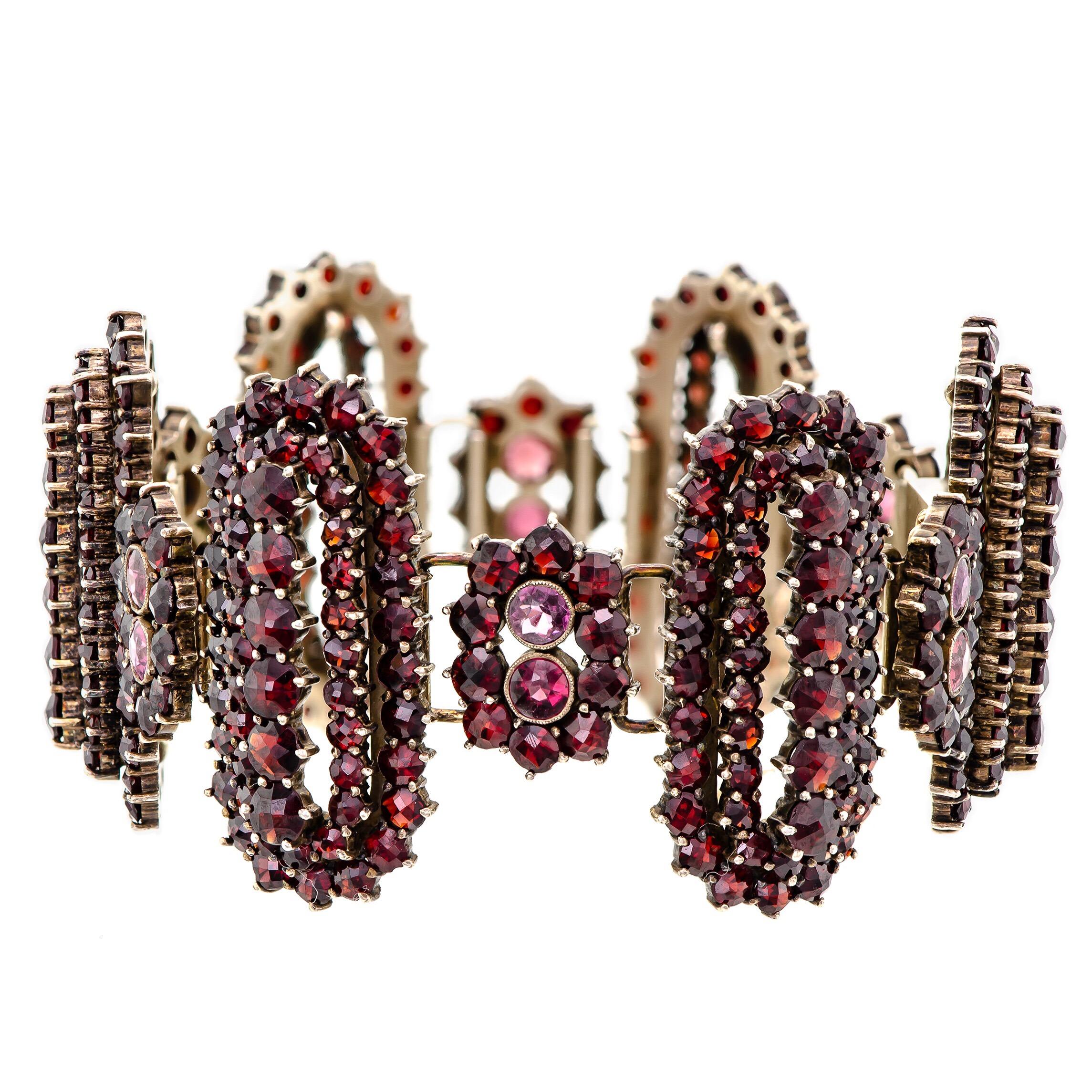 Magnificent vintage garnet and gilt hinged wide flexible bracelet - set with numerous dazzling rose cut garnets into a repeated alternating hinged pattern of small and large lozenge-shaped sections. The garnets are deep in color and set in gilt or