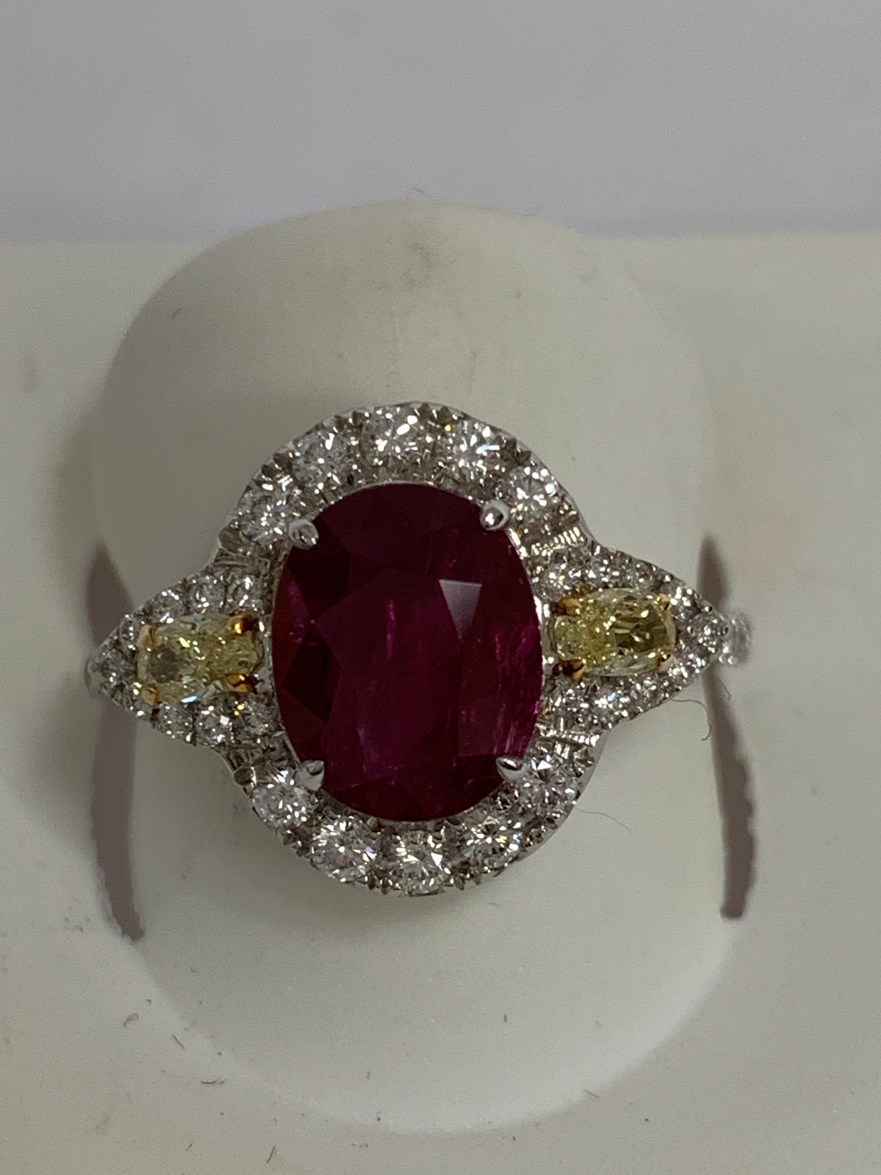 Natural Oval Ruby 1.66 Carat , yellow diamonds 0.24 and round white diamonds 0.35 Carat set in 14 karat two tone gold is one of a kind handcrafted ring. the ring is size 7 and can be resized if needed.