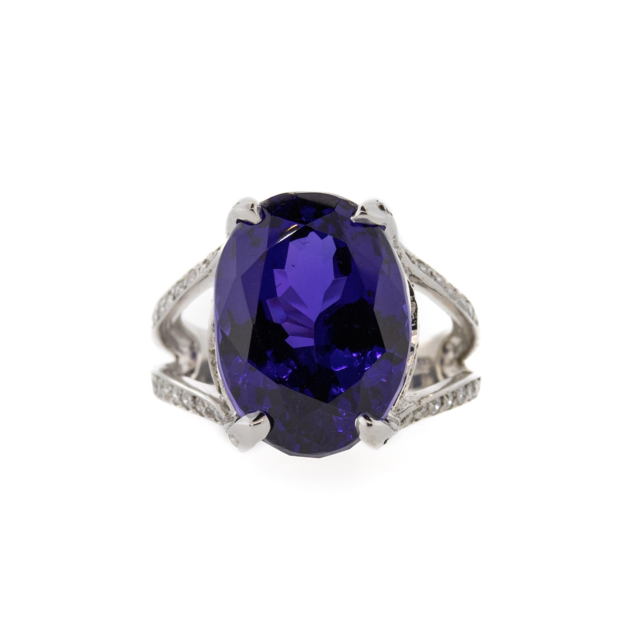 This amazing natural oval cut fine Tanzanite is the violet/blue color that lovers of the gem swoon over. The Tanzanite is 16.79ct and has .75ctw of G-H/VS-SI diamonds running down the shank and through the undercarriage of this 14k white gold ring.