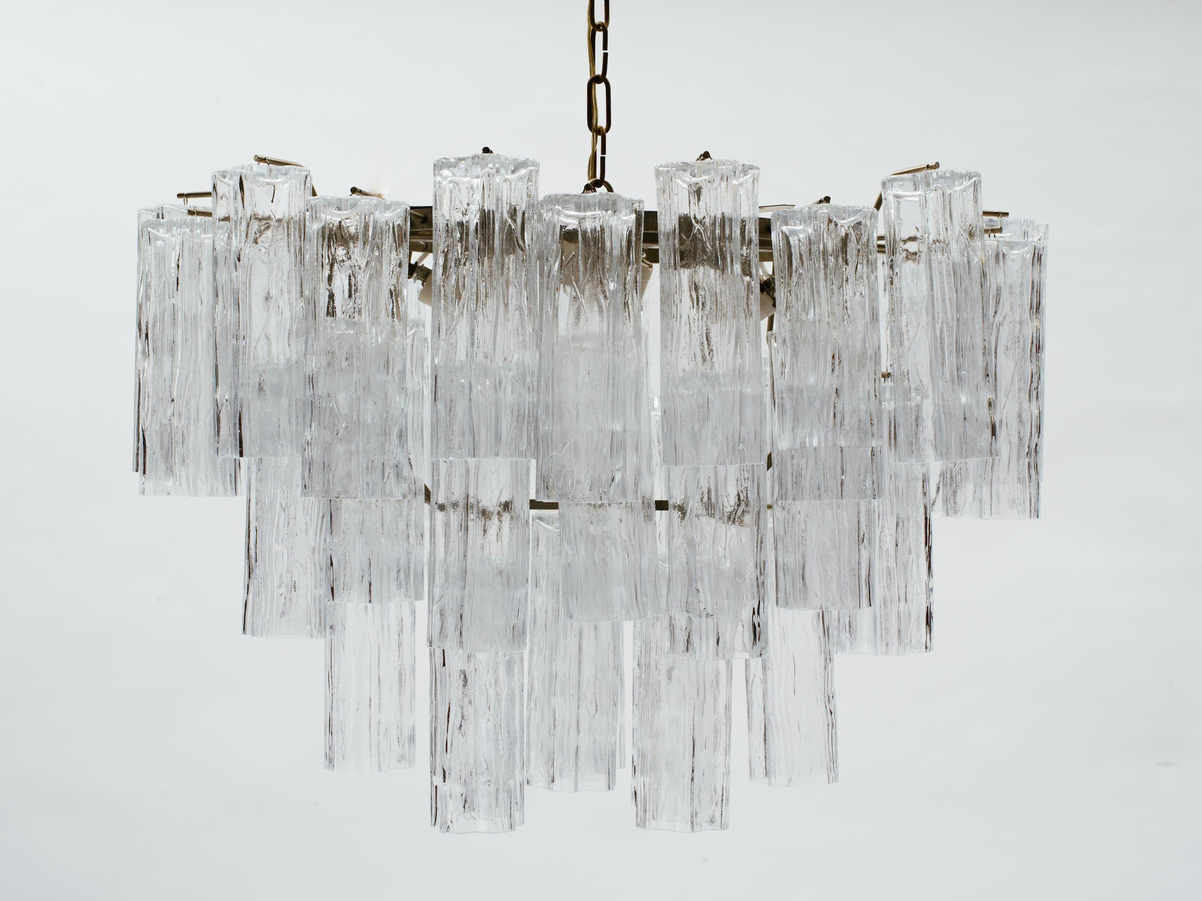 Large oval Italian glass tube tiered chandelier in the manner of Venini. Steel frame body hangs from link chain, labeled Made In Italy. Chandelier body measures 18