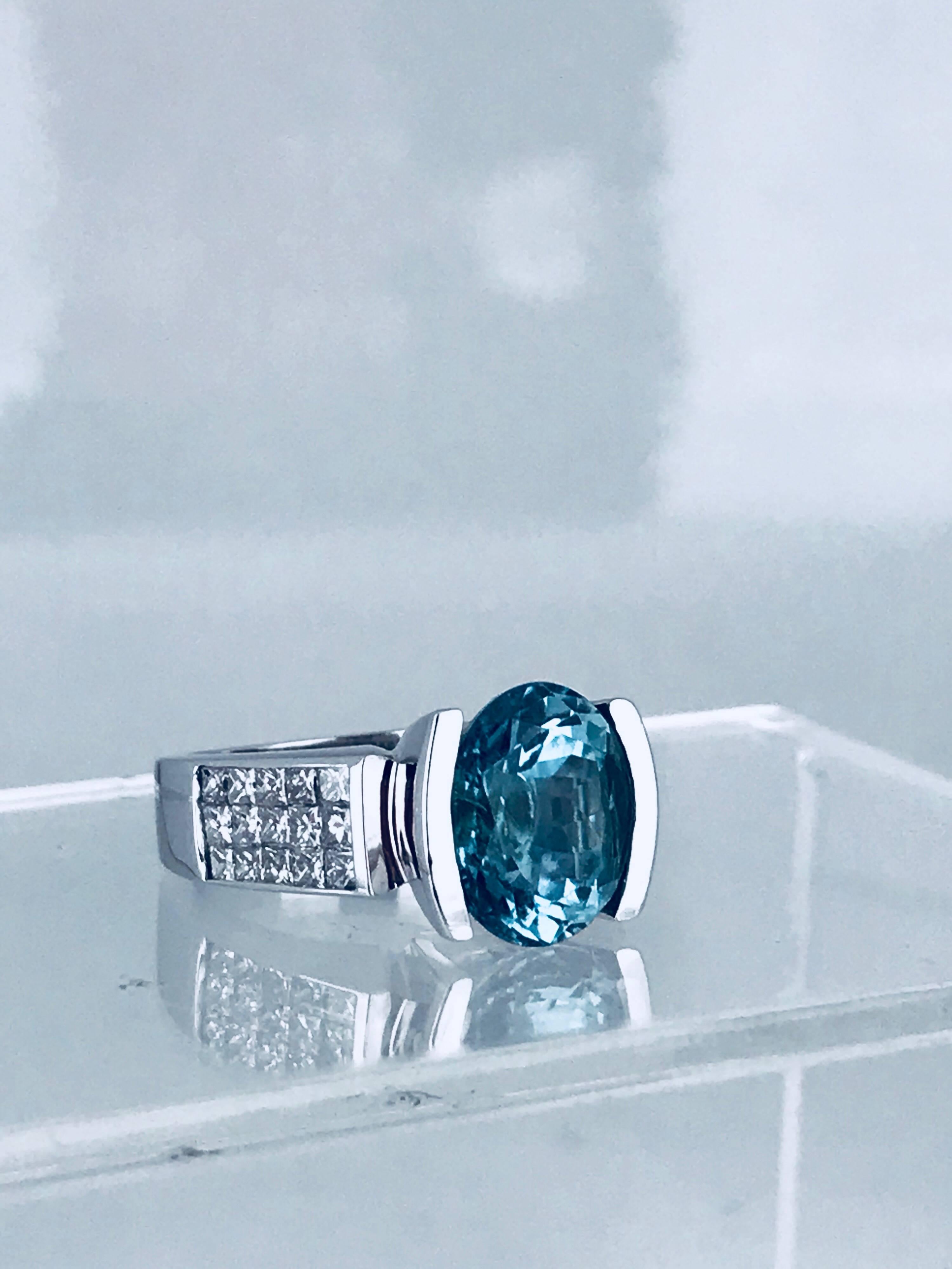 18 Karat white gold diamond and Paraiba gemstone. Rare and beautiful color weighing approximately 5.00 carats.  The measurements are 11.87-9.6 x 7.95 millimeters. 

The setting consists of (30) princess cut diamonds having a total weight of 1.05