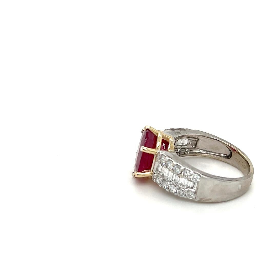 One 18 karat white gold ring, prong set in 18 karat yellow gold with one oval natural ruby, approximately 5.71 carat, flanked by twenty (20) round brilliant cut diamonds, approximately 0.50 carat total weight with matching H/I color and SI1 clarity,
