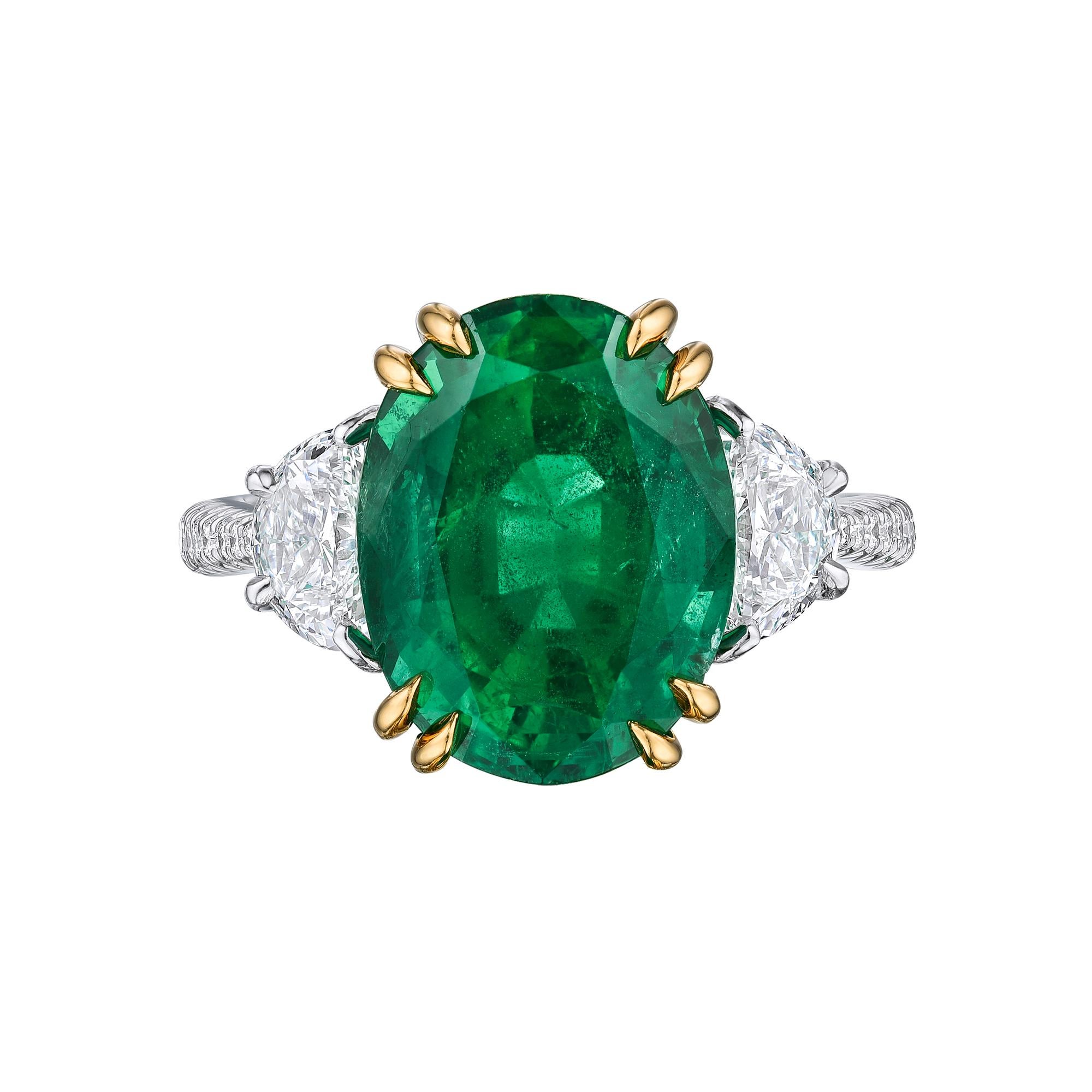 GIA Certified Oval Emerald Cocktail Ring set in Platinum with 18K yellow gold prongs. 5.72 Intense green Emerald stone set in platinum with half moon and brilliant round cut diamonds. Center stone is 5.72 carats, side stones: 1.20 carats F-G