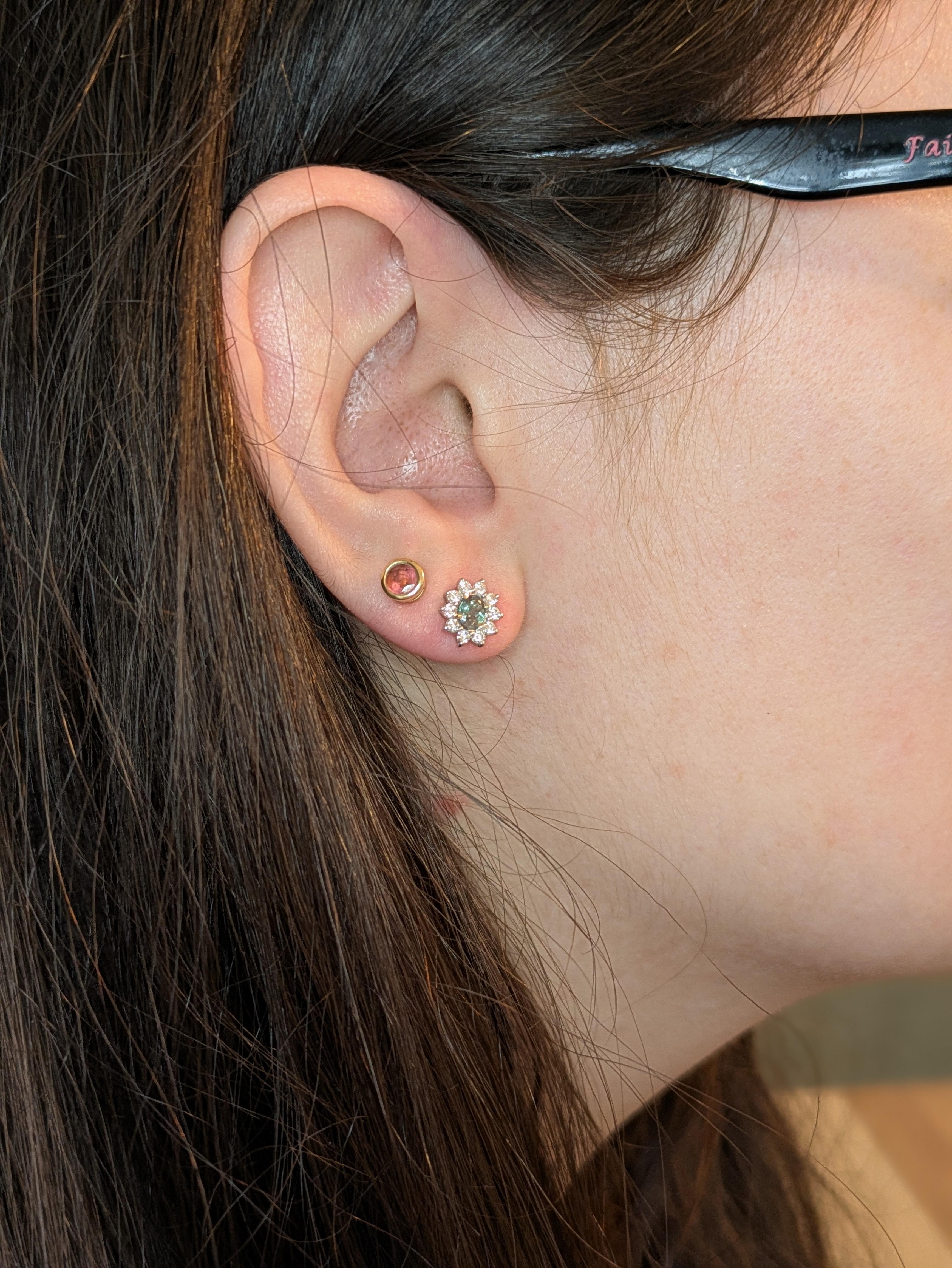 Add timeless elegance to your collection with these natural color-changing alexandrite studs. Set in solid 14K white gold, each stone is framed by a sparkling halo of earth-mined diamonds, creating a luxurious and eye-catching