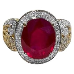 Vintage Oval 7.5 Carat Treated Ruby and 1 Carat Diamond 14 Karat Yellow Gold Ring