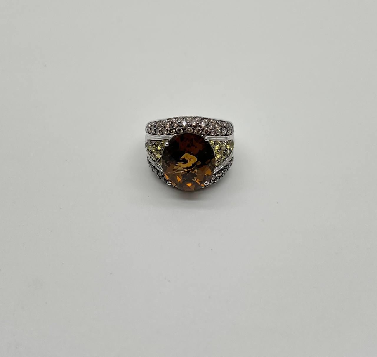 A bold interplay of texture and hue.

This striking statement ring features a captivating orange amber citrine at its center. The oval-cut gem is embraced by a series of shimmering diamonds and yellow sapphires, creating a layered effect that draws