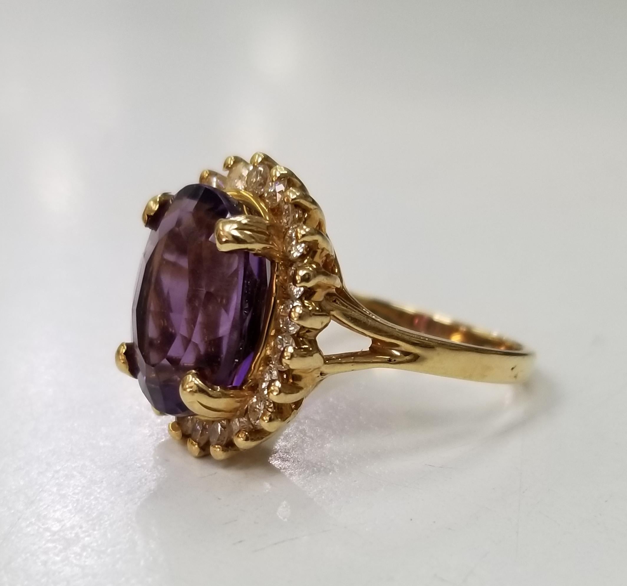 14k yellow gold amethyst and diamond ring, containing 1 oval cut amethyst of gem quality weighing 12.00cts. and 22 round full cut diamonds of very fine quality weighing .56pts. This ring is a size 6 but we will size to fit for free.