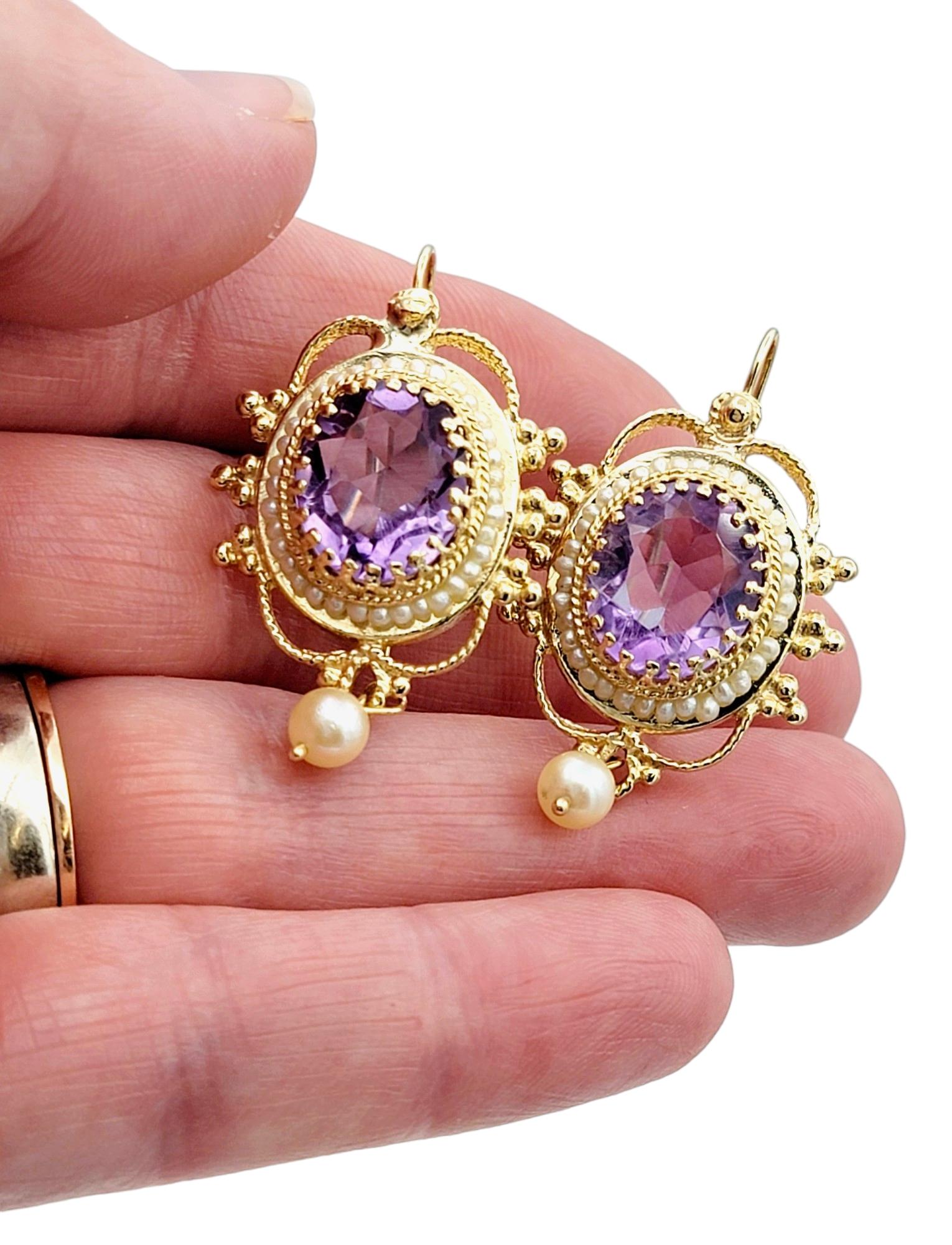 Women's Oval Amethyst and Seed Pearl Halo Dangle Earrings Set in 14 Karat Yellow Gold For Sale