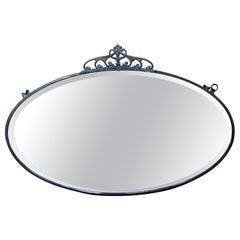 Oval antique Art Nouveau mirror with a thin brass frame and crown