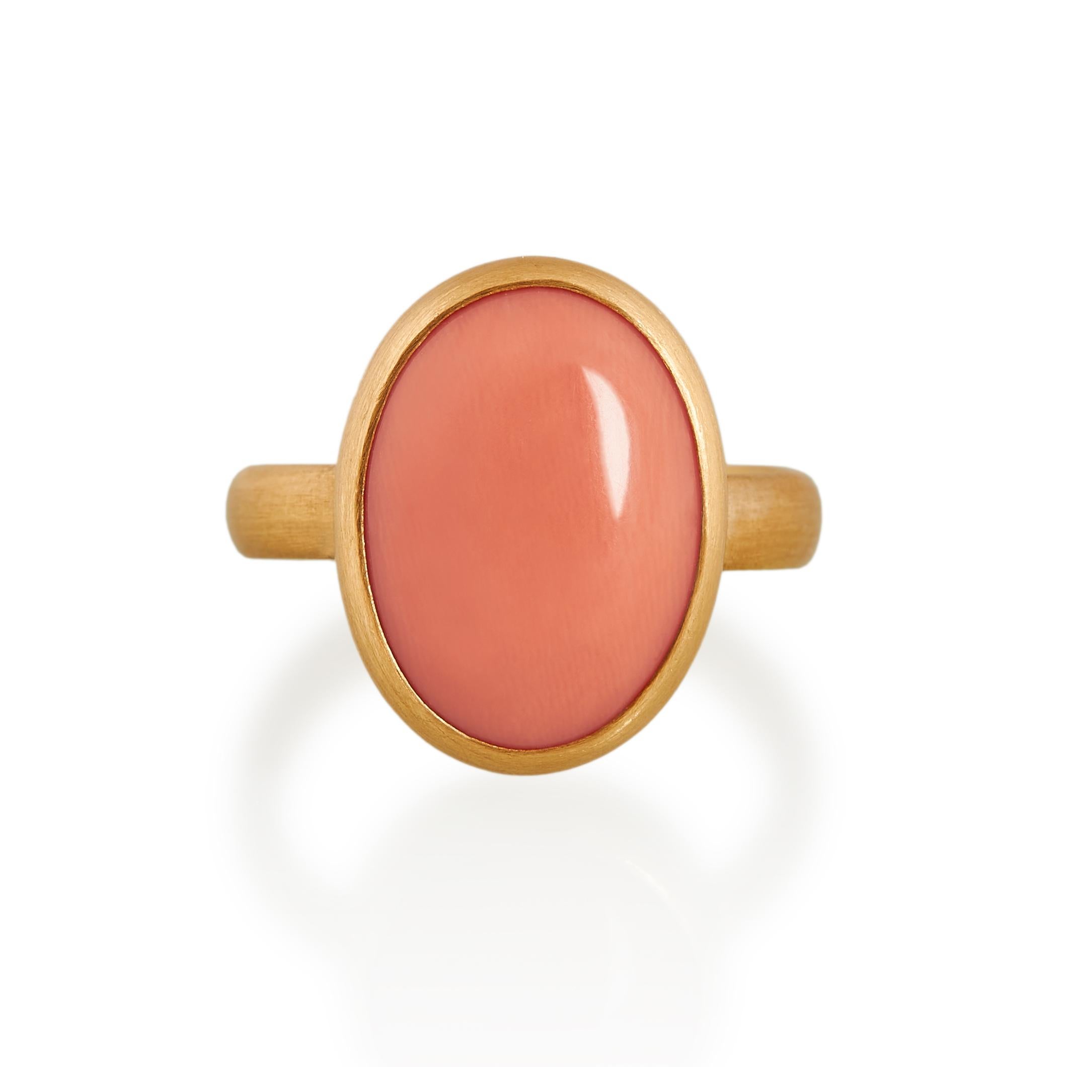 Antique oval cabochon cut coral ring with a wonderful peachy colour. Set in matte finished 22ct gold with a fine platinum inlay on the underside of the stone setting. 
Ref: G20005

8.41cts (18mm x 14mm) oval antique coral
22ct gold with platinum