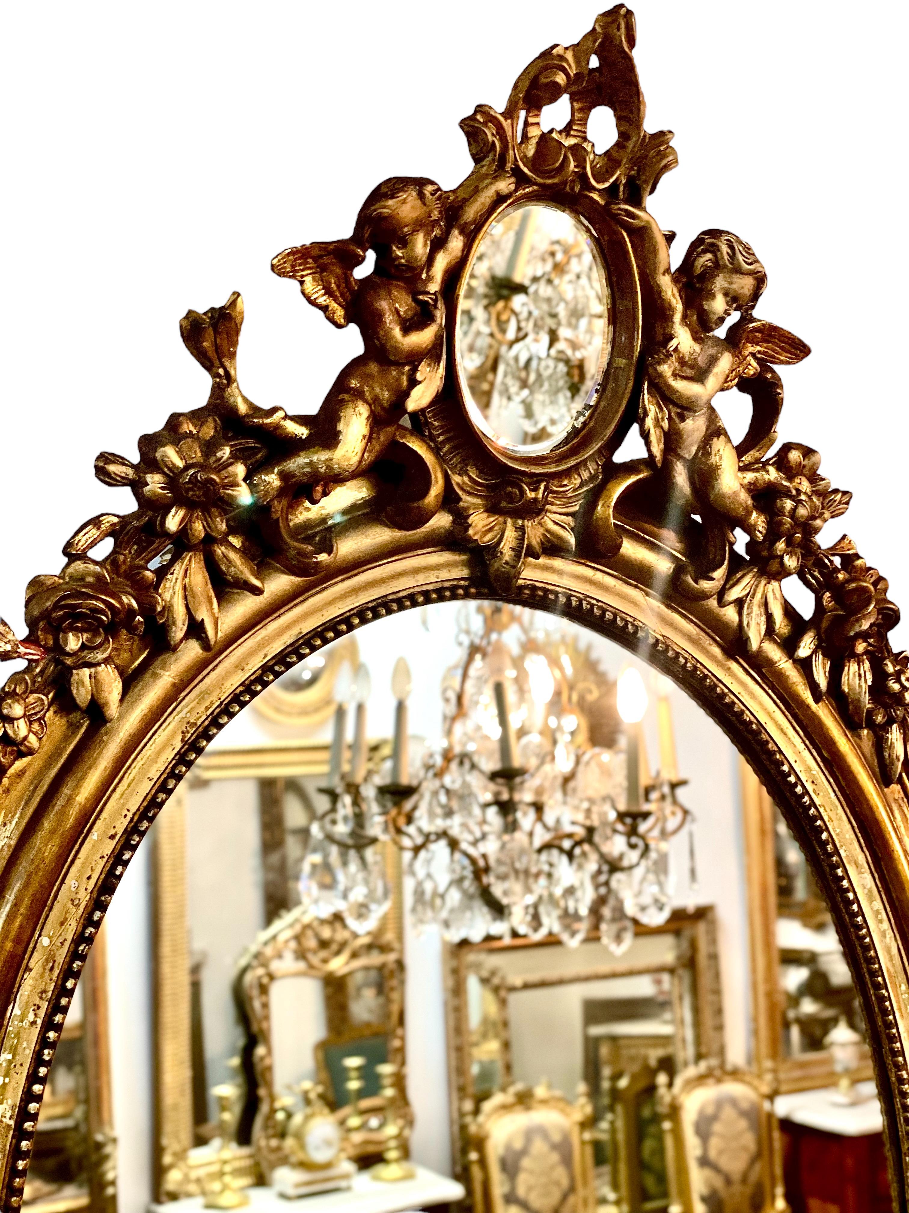 19th Century French Antique Oval Giltwood Mirror with Cherubs For Sale