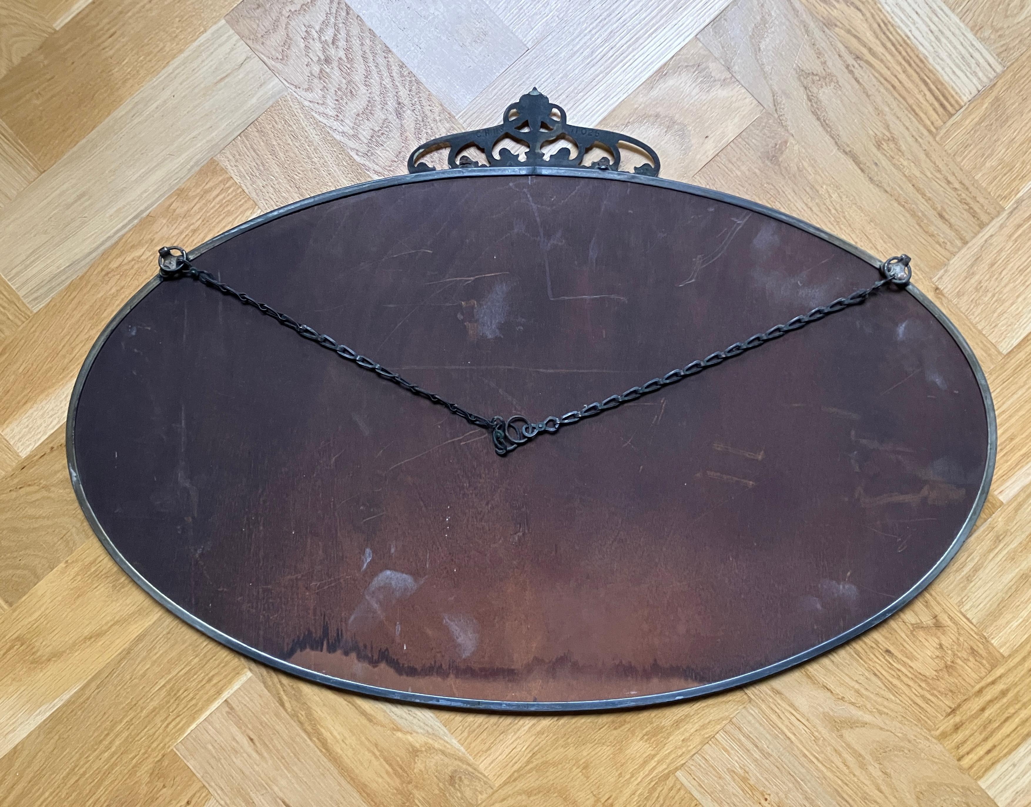 Oval antique Art Nouveau mirror with a thin brass frame and crown  For Sale 3