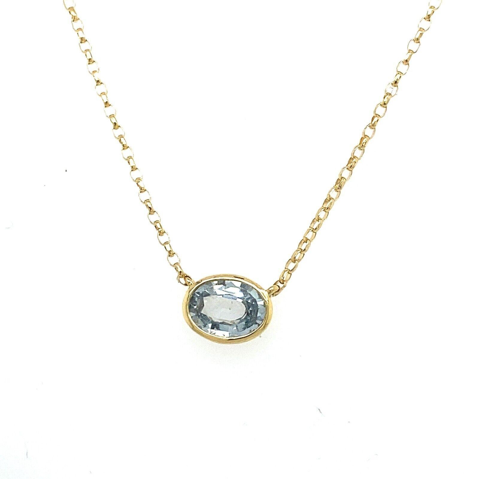 This beautiful pendant rubover setting is set with a 0.75ct oval shaped Aquamarine gemstone. The gem is set in an 18ct Yellow Gold frame, suspended on 16