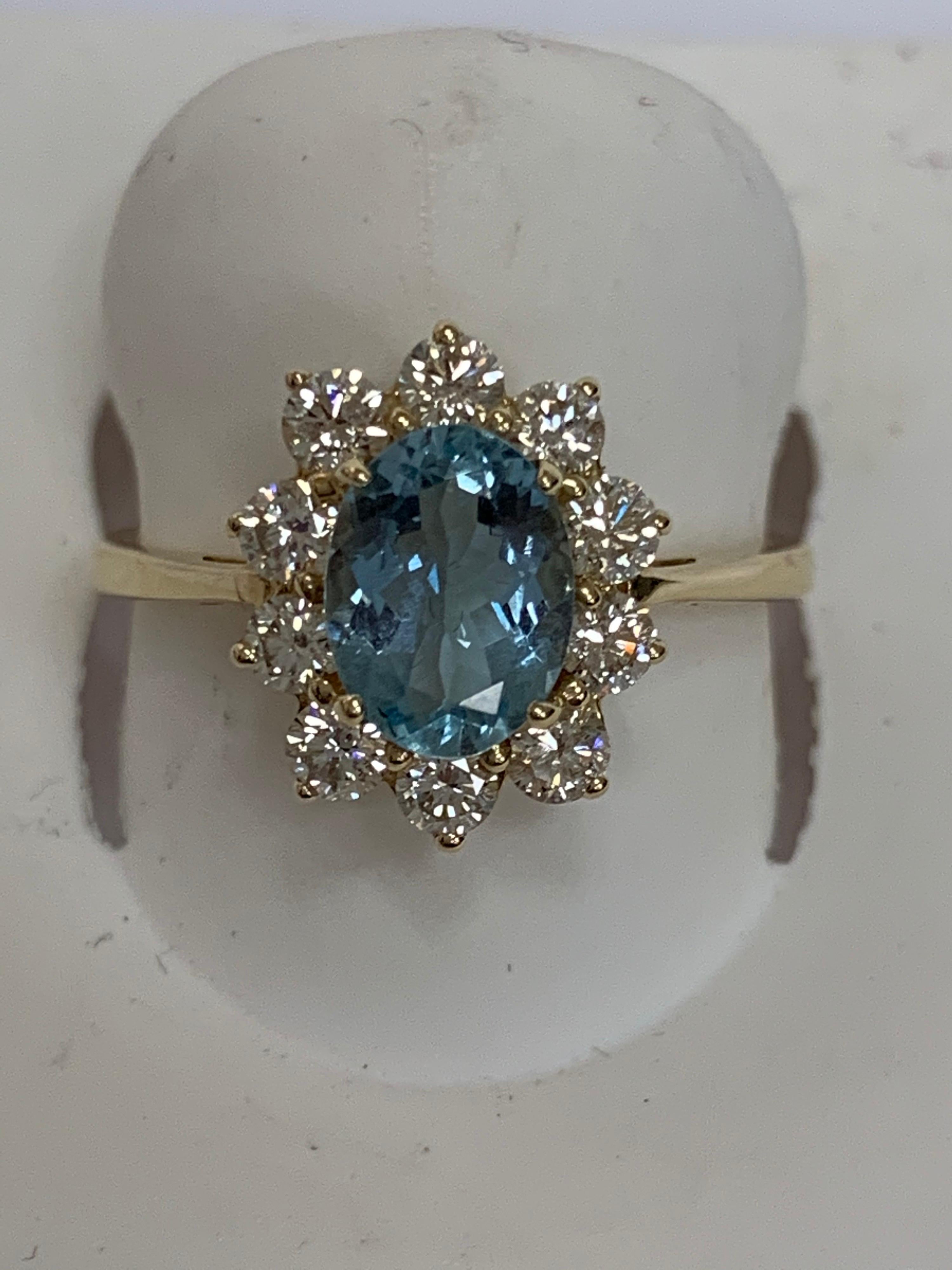 Natural Oval 1 Carat Aquamarine with 0.63 Carat white round diamonds set in 14 Karat yellow gold is one of a kind handcrafted ring. The size of the ring is 7 and can be resized if needed.